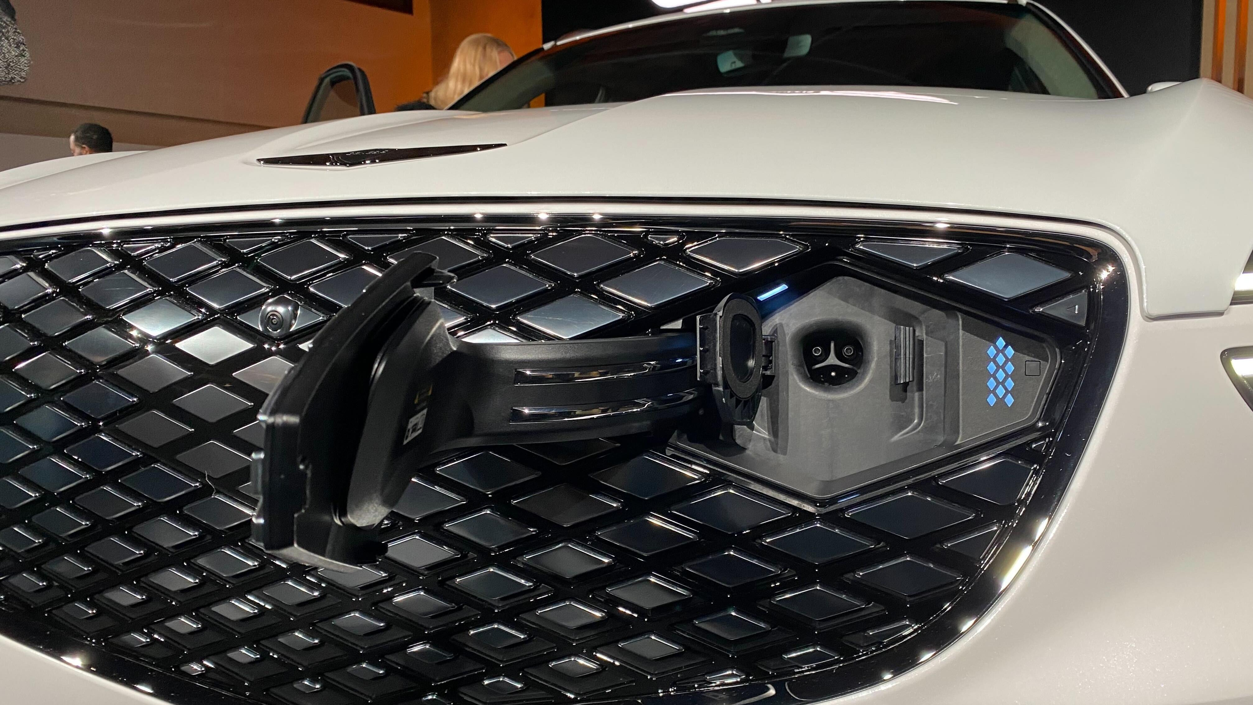 A close up of the GV70 Electrified grille and the new NACS charging port