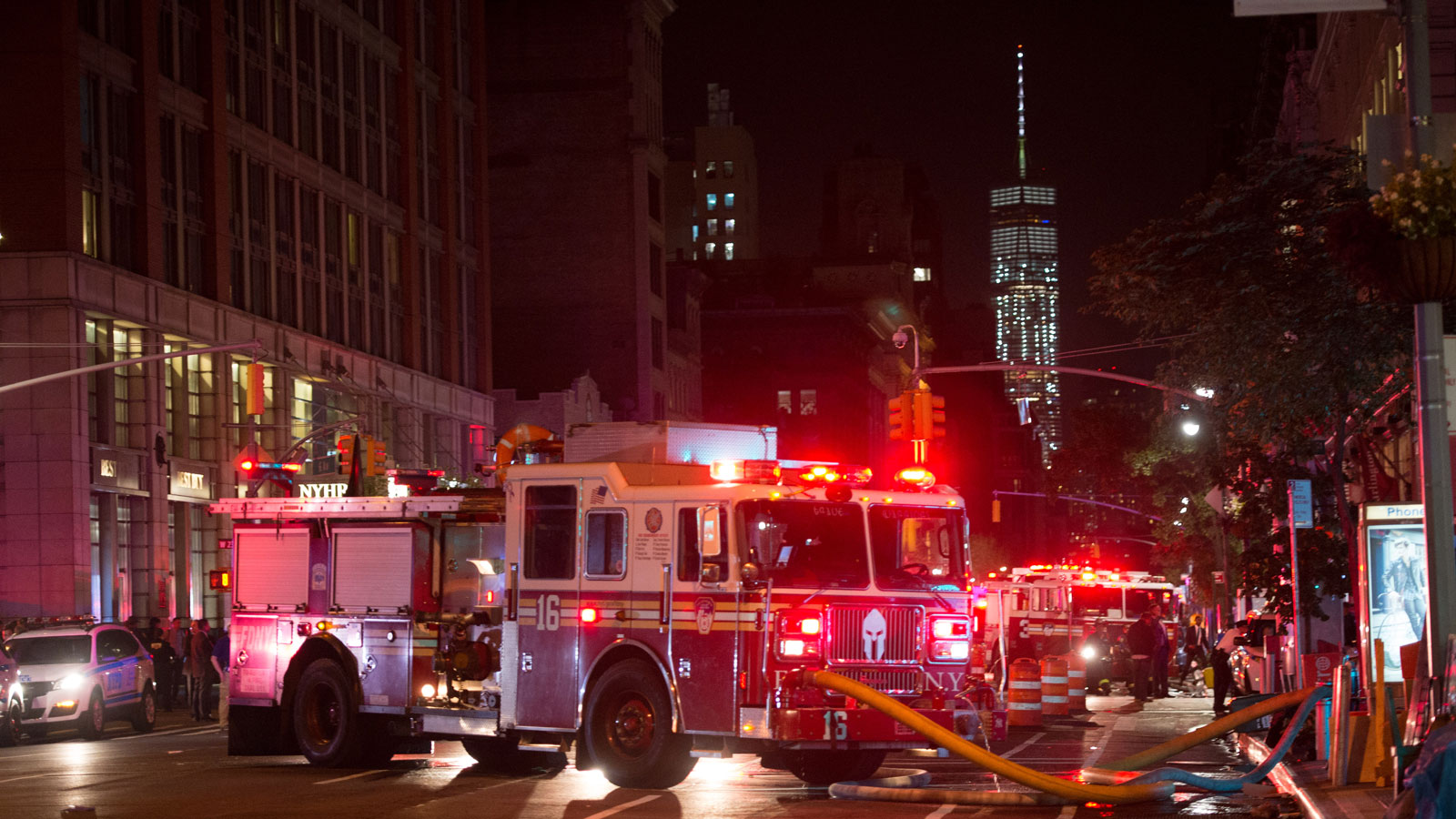 A photo of a fire truck in New York City with its lights flashing. 