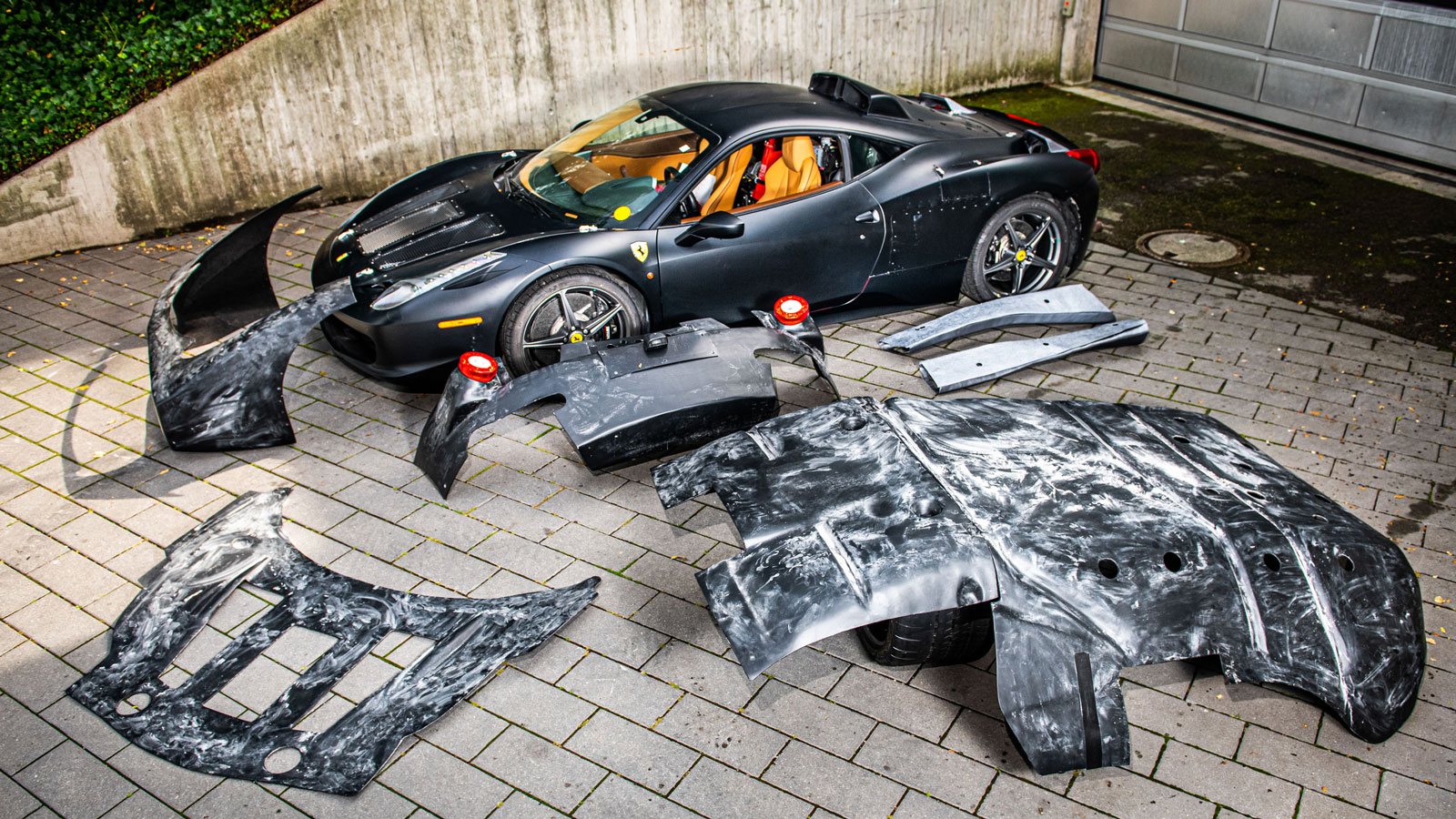 A photo of the Ferrari mule car with all its coverings on the side. 