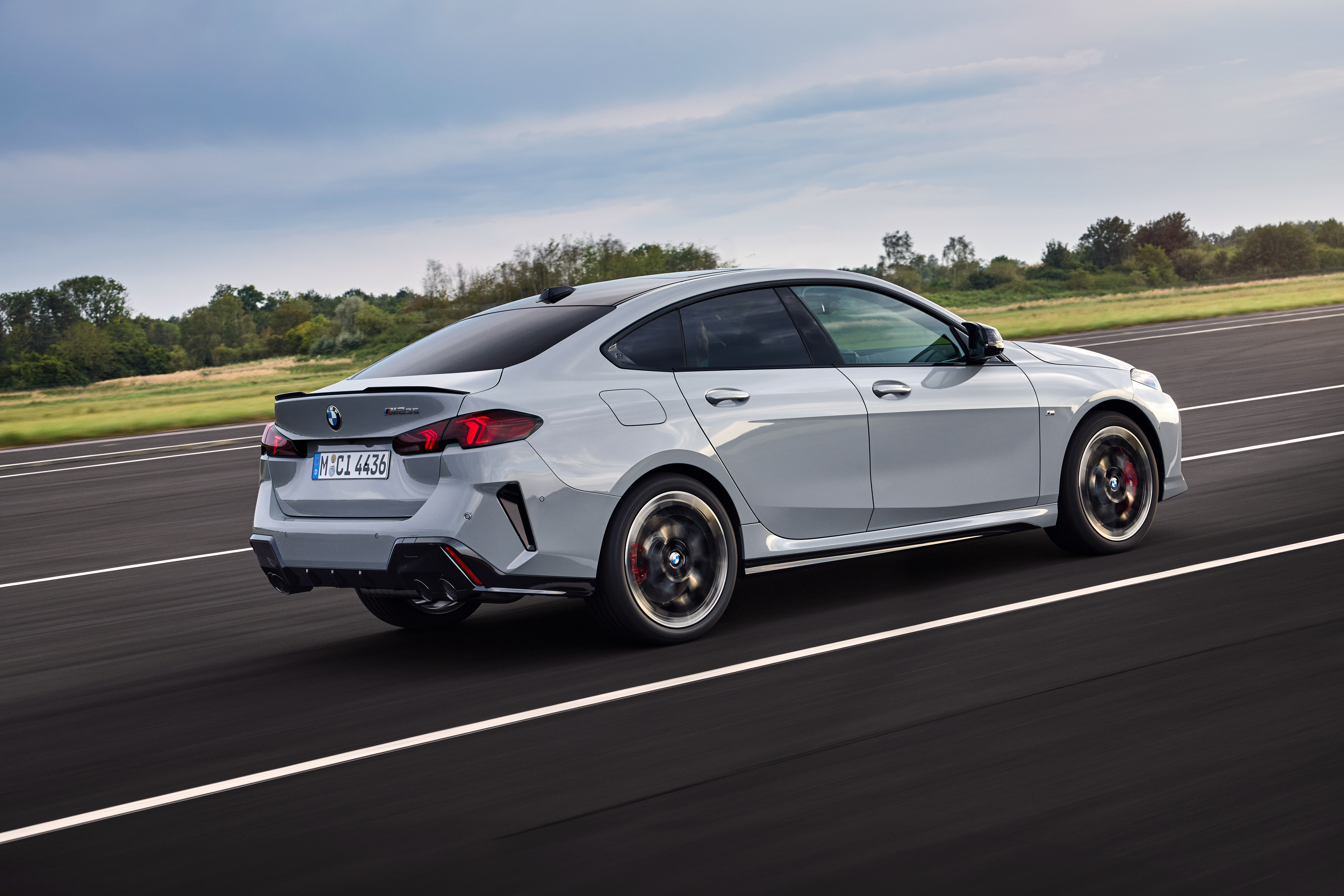 A rear three quarters shot of a gray m235i GC 