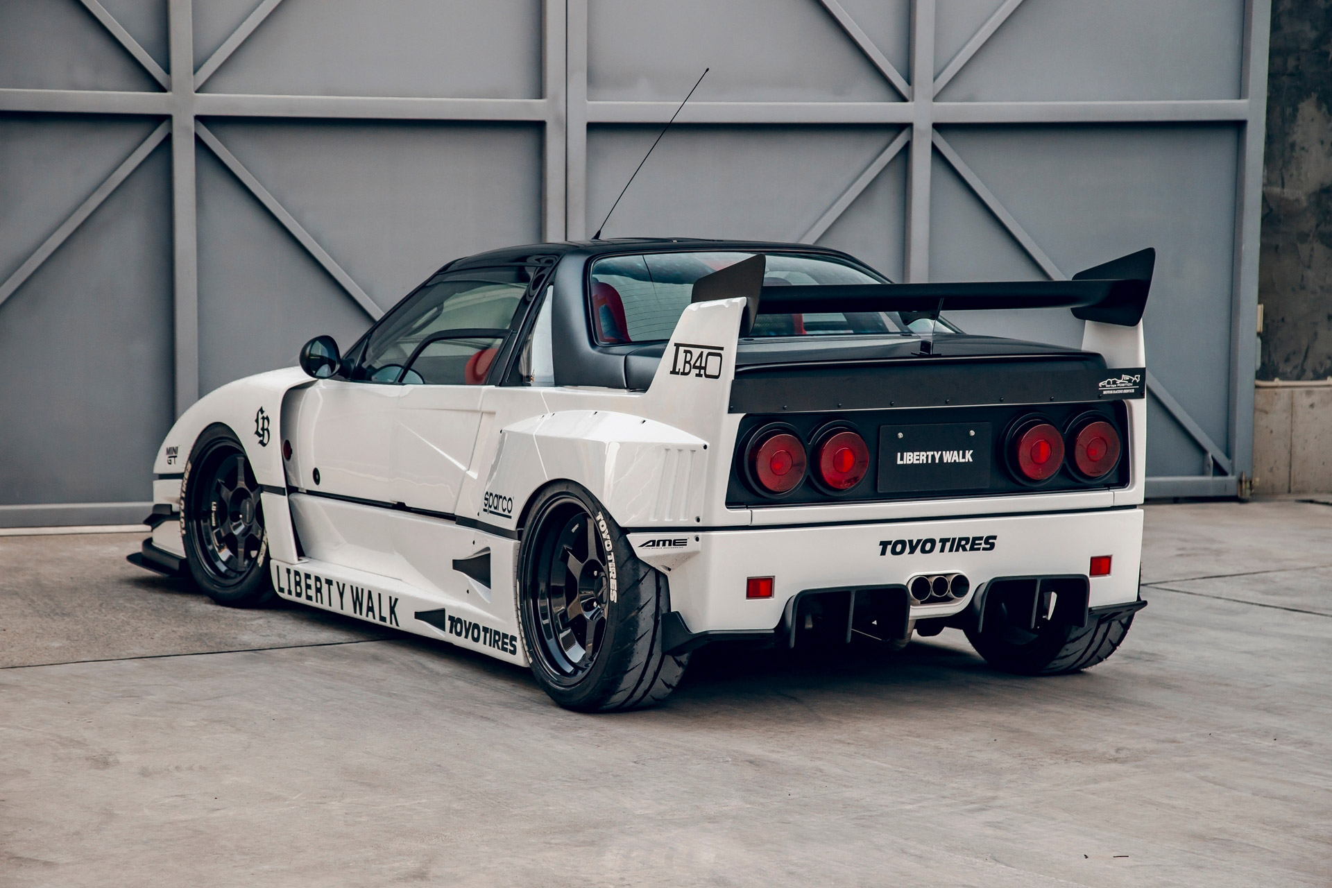 Rear 3/4 view of a white Autozam AZ-1 with a Ferrari F40 bodykit