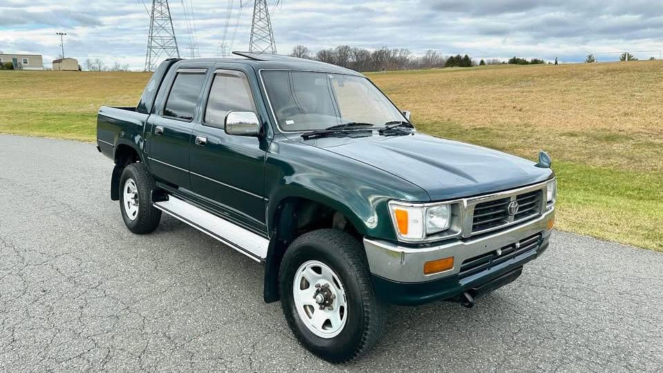 A photo from the marketplace ad showing the green Hilux from the front three quarters angle