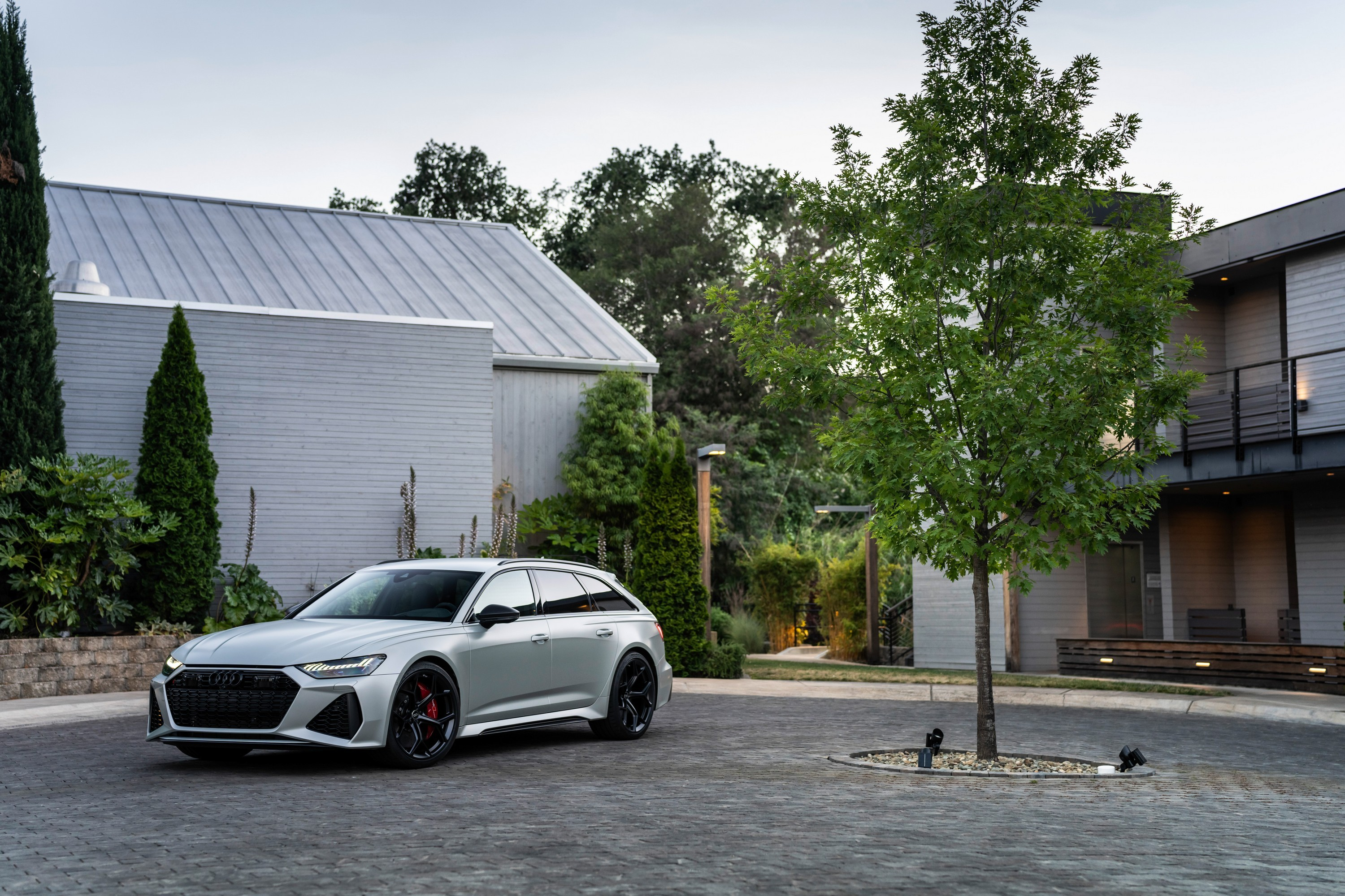 The 2024 Audi RS 6 Avant Performance parked in a roundabout, front-three-quarter view