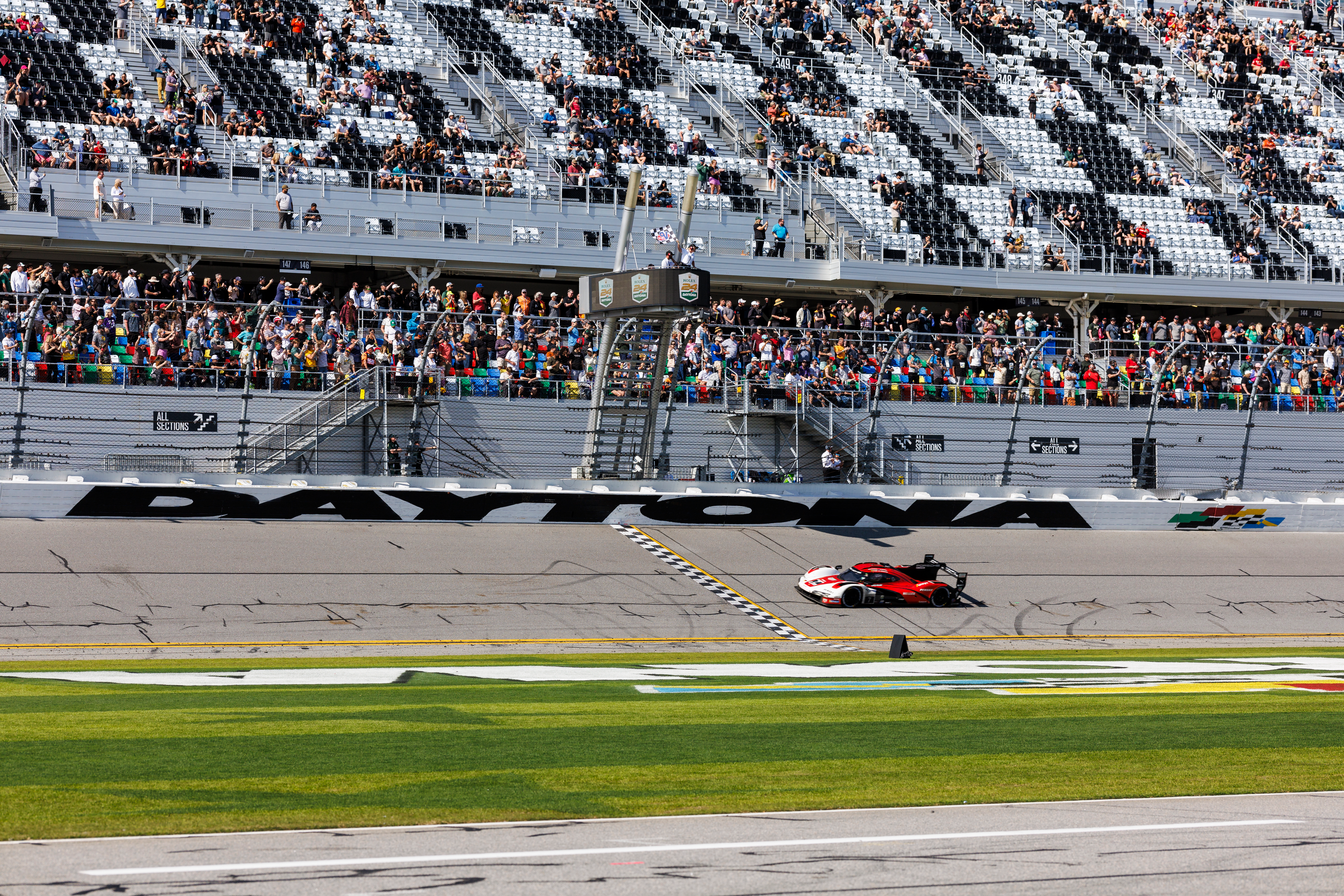 Felipe Nasr driver of the #7 Porsche Penske Motorsport Porsche 963 crosses the finish line to win the Rolex 24 at Daytona International Speedway on January 28, 2024 in Daytona Beach, Florida.