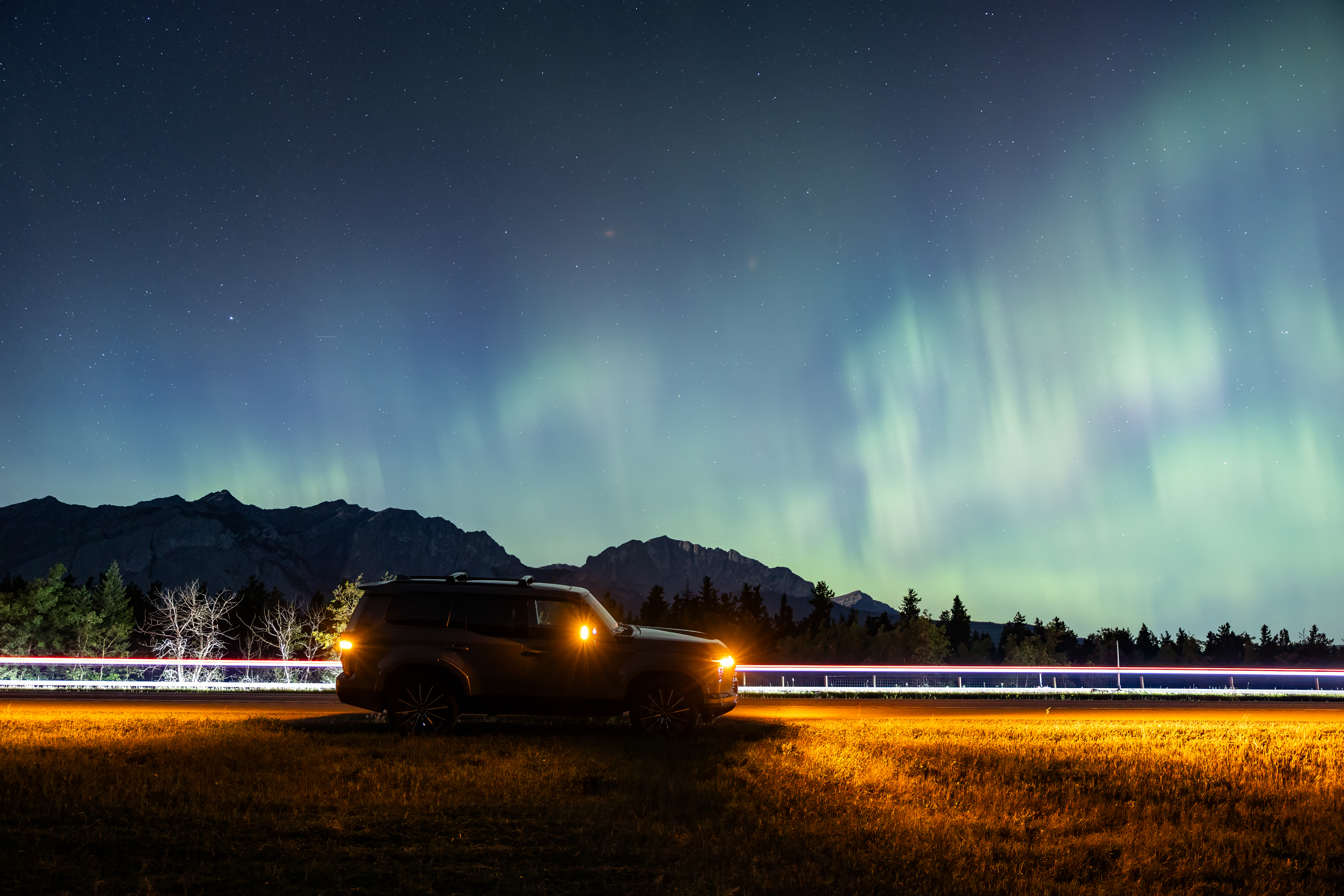 Side view of a Lexus GX 550 with the northern lights in the background