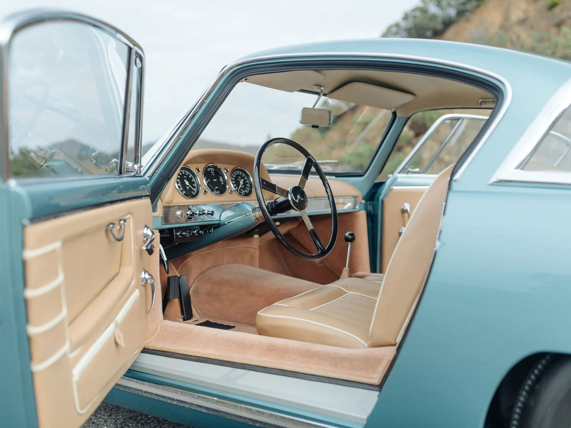 Interior view of a teal Aston Martin DB2/4 by Bertone