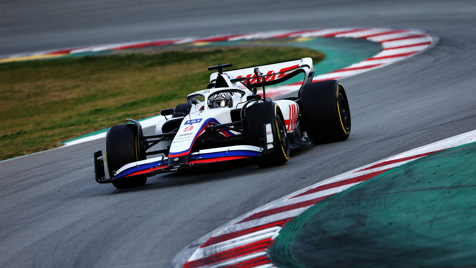 A photo of Nikita Mazepin driving his F1 car in Testing. 