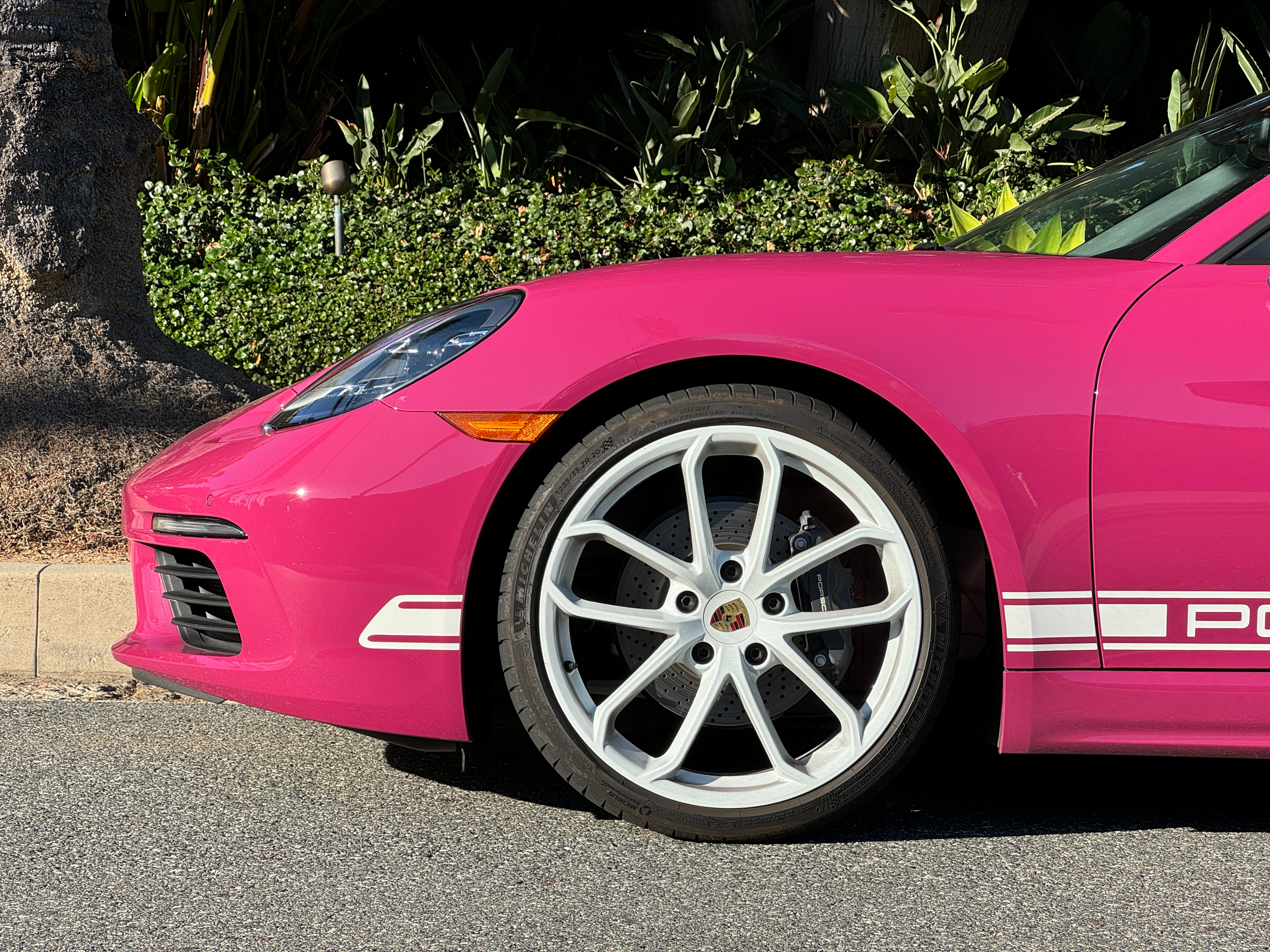 Front wheel of a pink Porsche 718 Boxster Style Edition