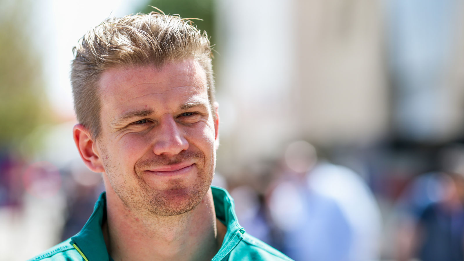 A photo of racing driver Nico Hulkenberg in Aston Martin gear. 