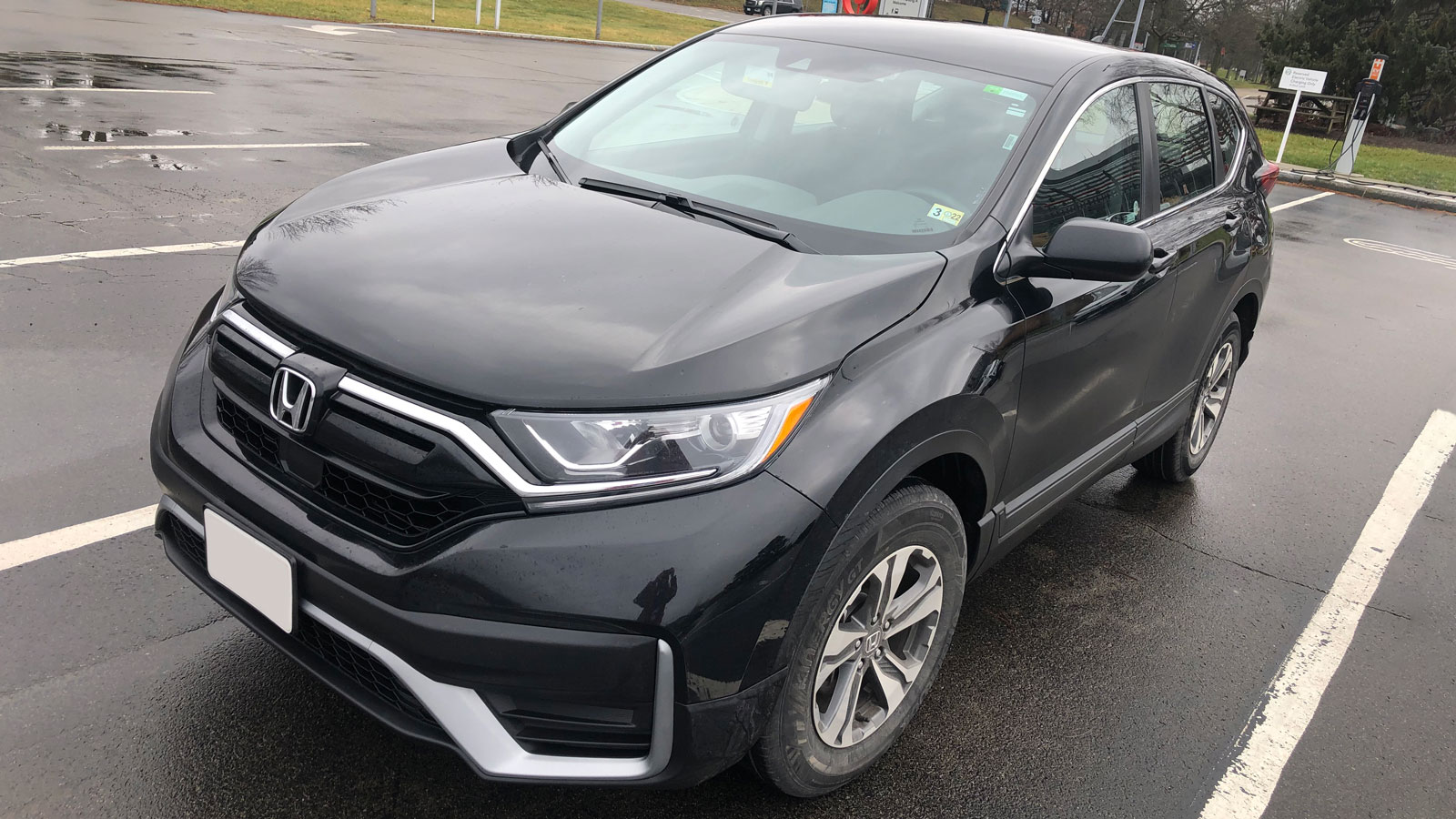 A photo of a black Honda CR-V SUV stopped in a parking lot 