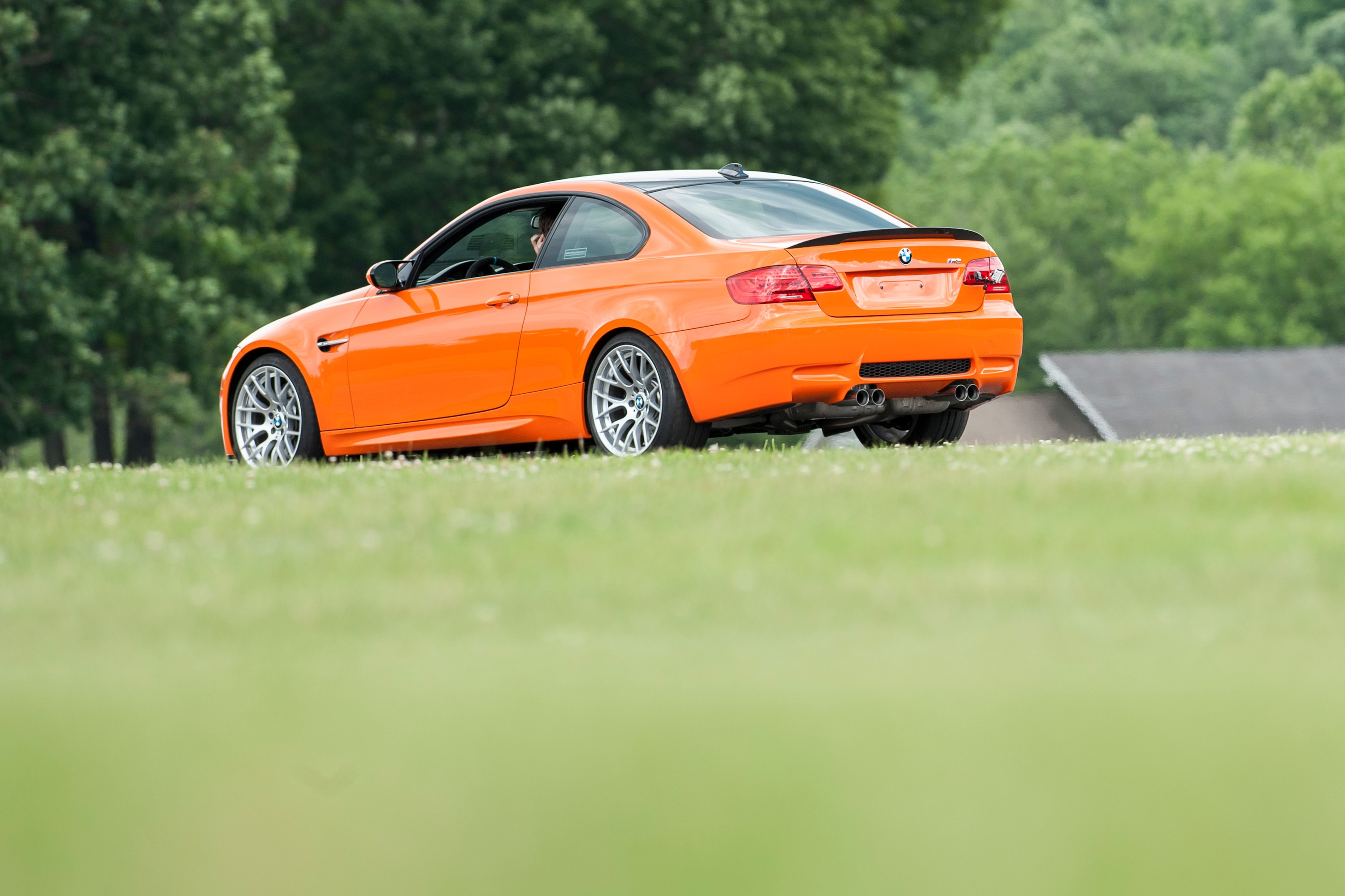 The back end of an orange BMW M3