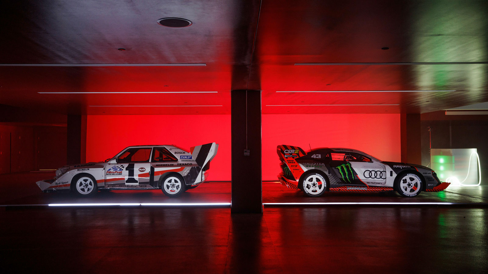 A photo of two Audi race cars parked back to back. 