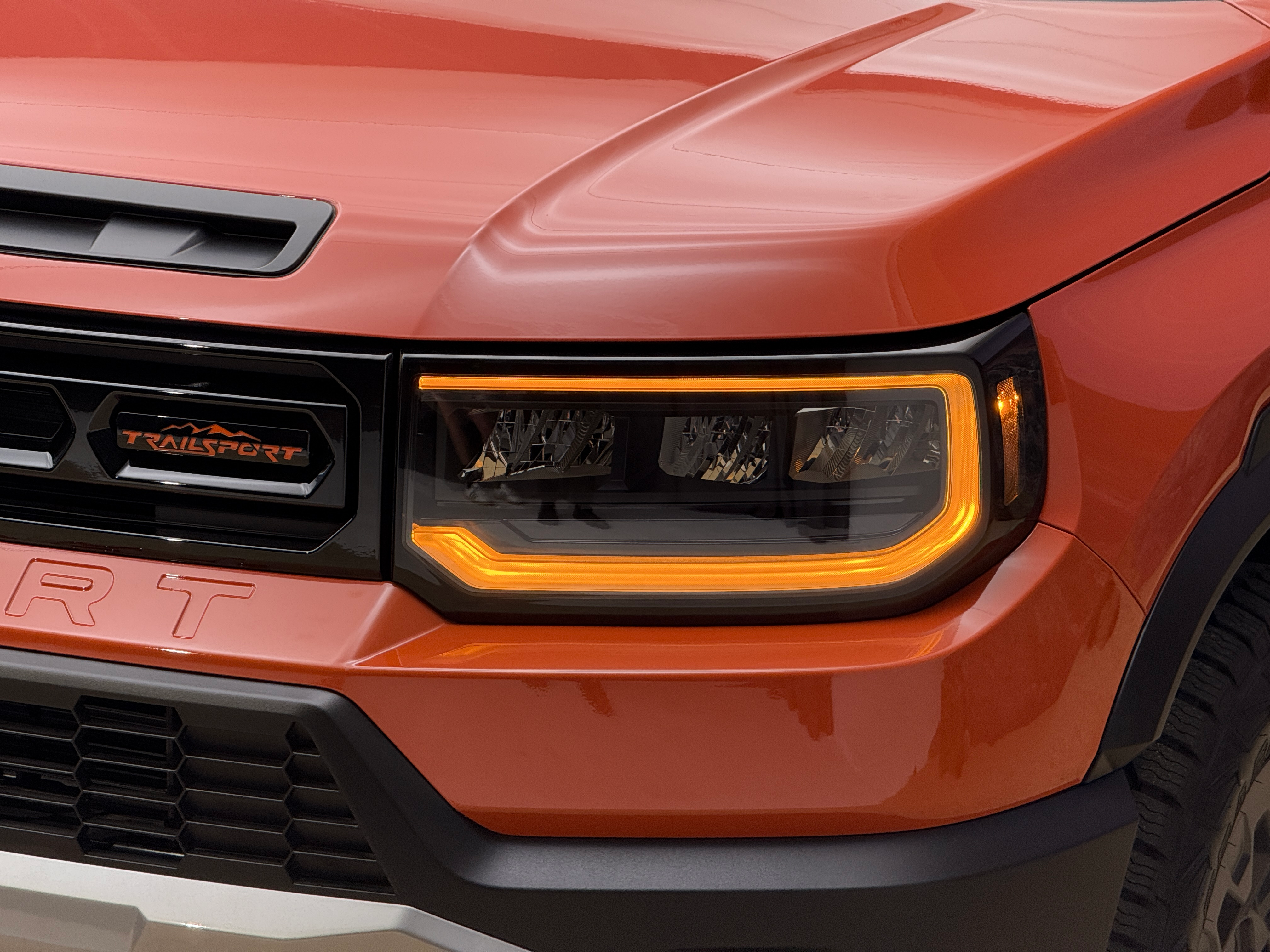 Headlight of an orange 2026 Honda Passport TrailSport