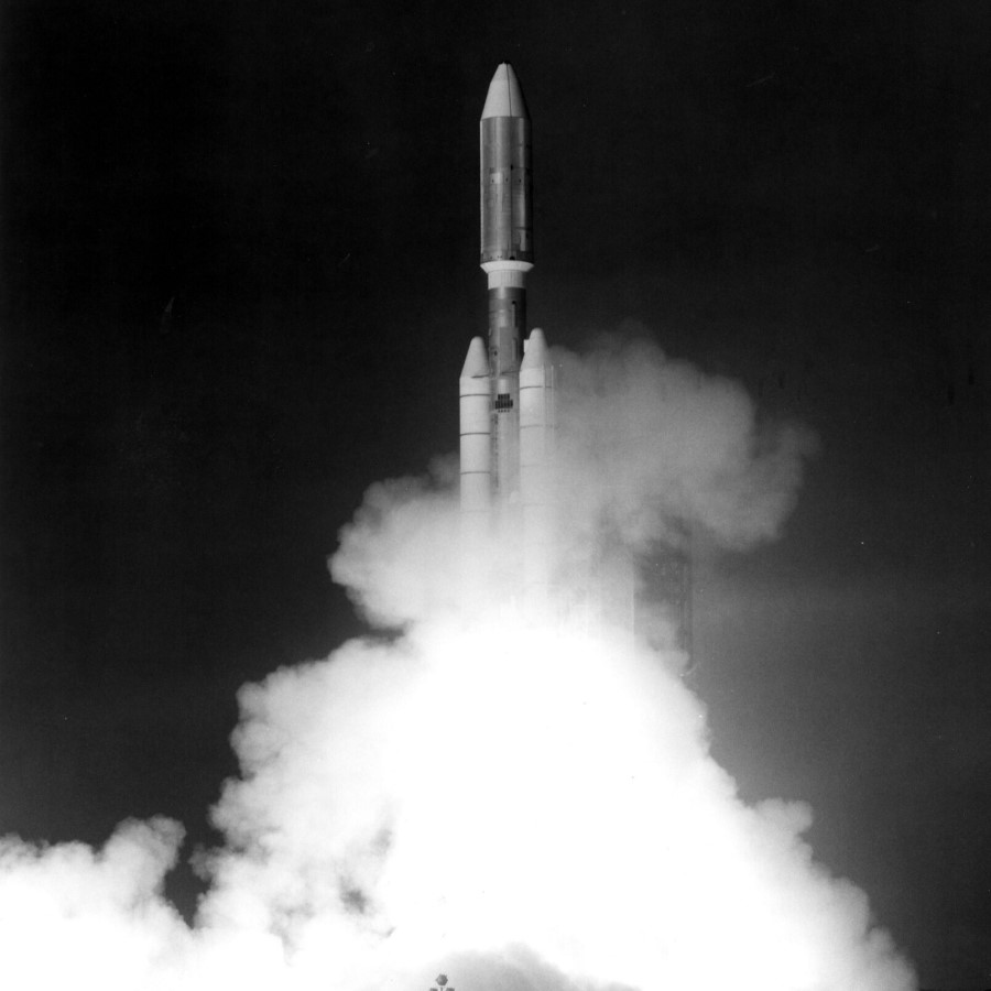 A black and white photo of a space rocket launching. 