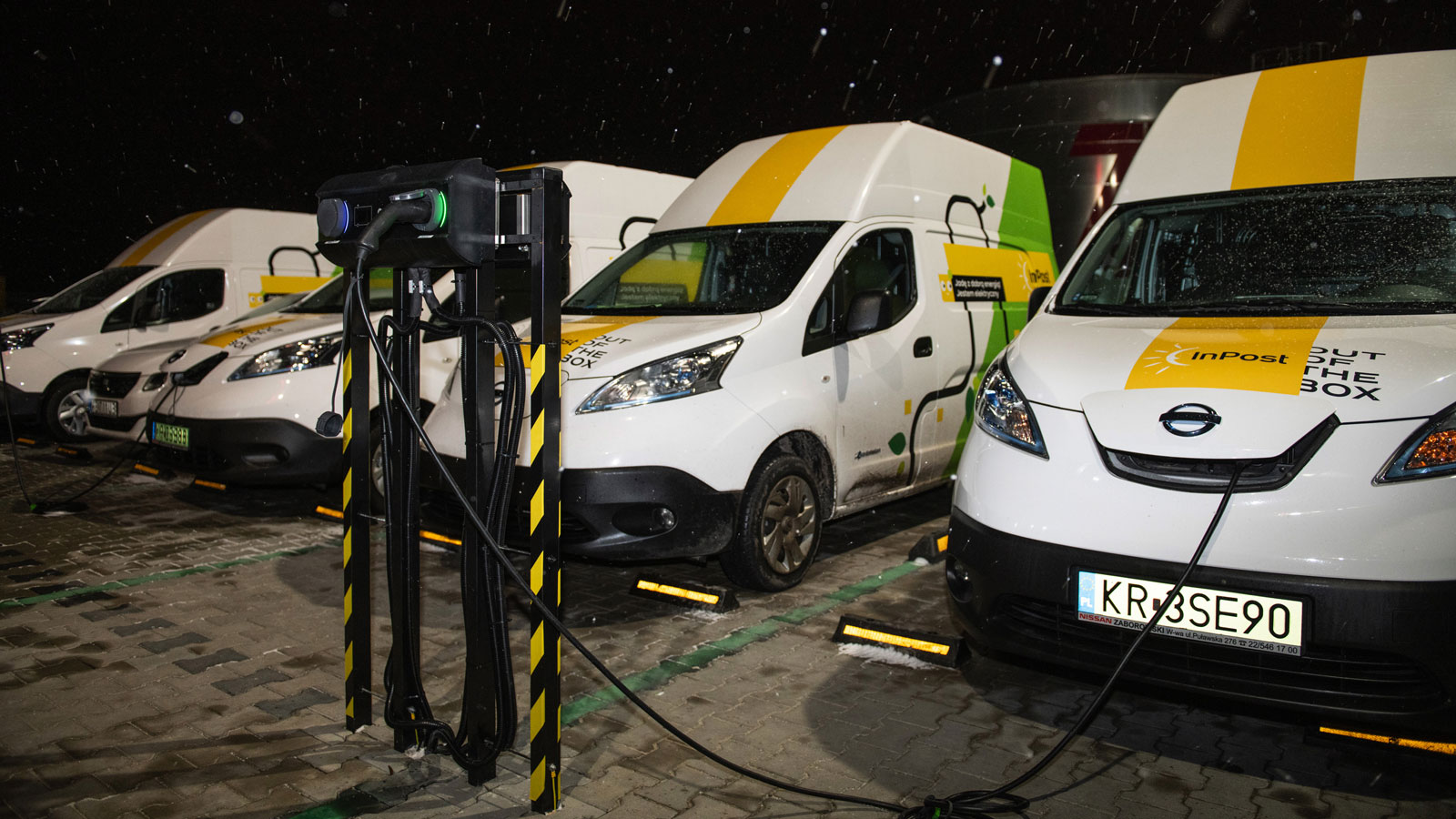 A photo of five electric vans on charge in Europe. 