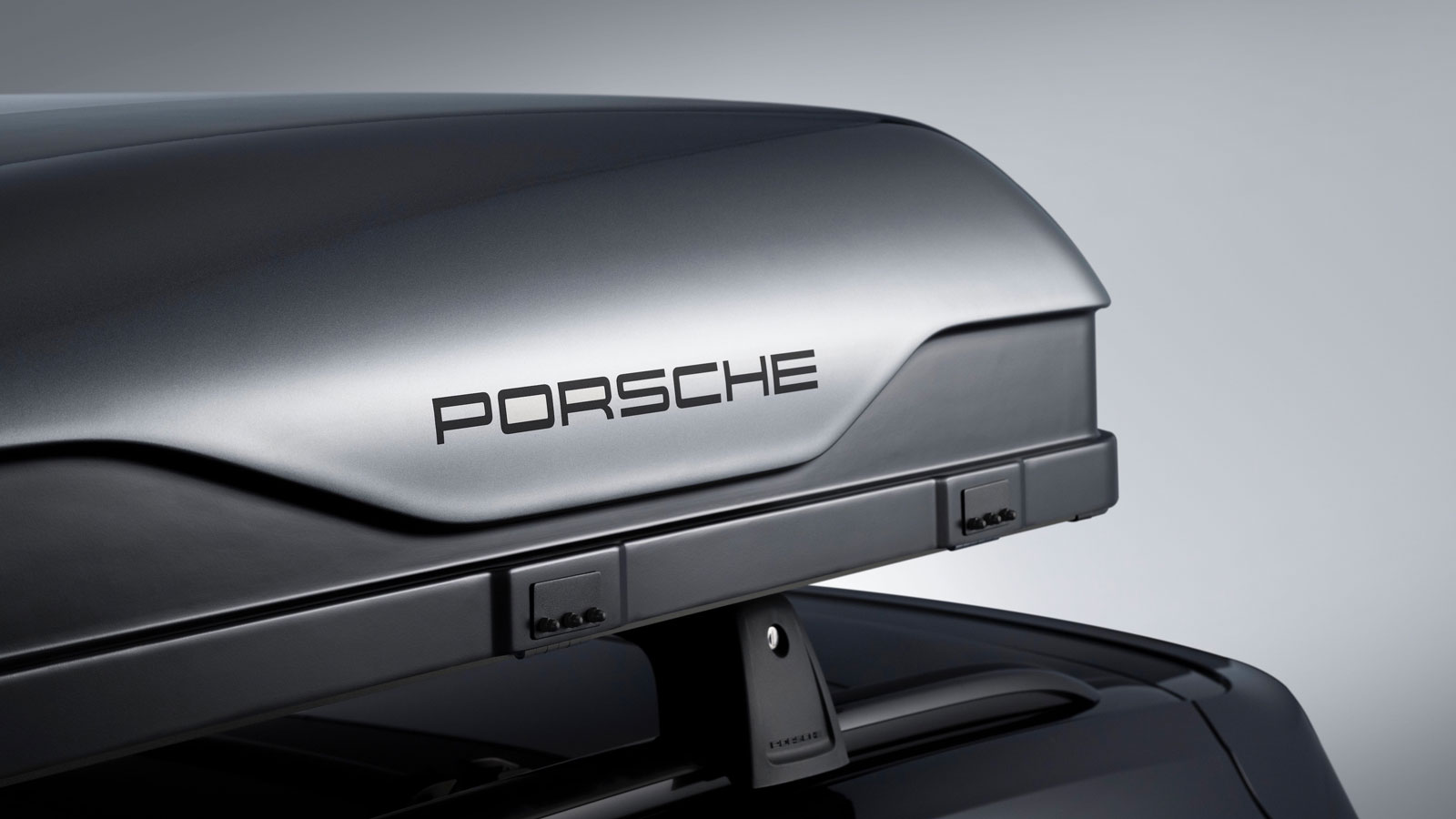 A close up photo of the Porsche logo on a roof top tent. 