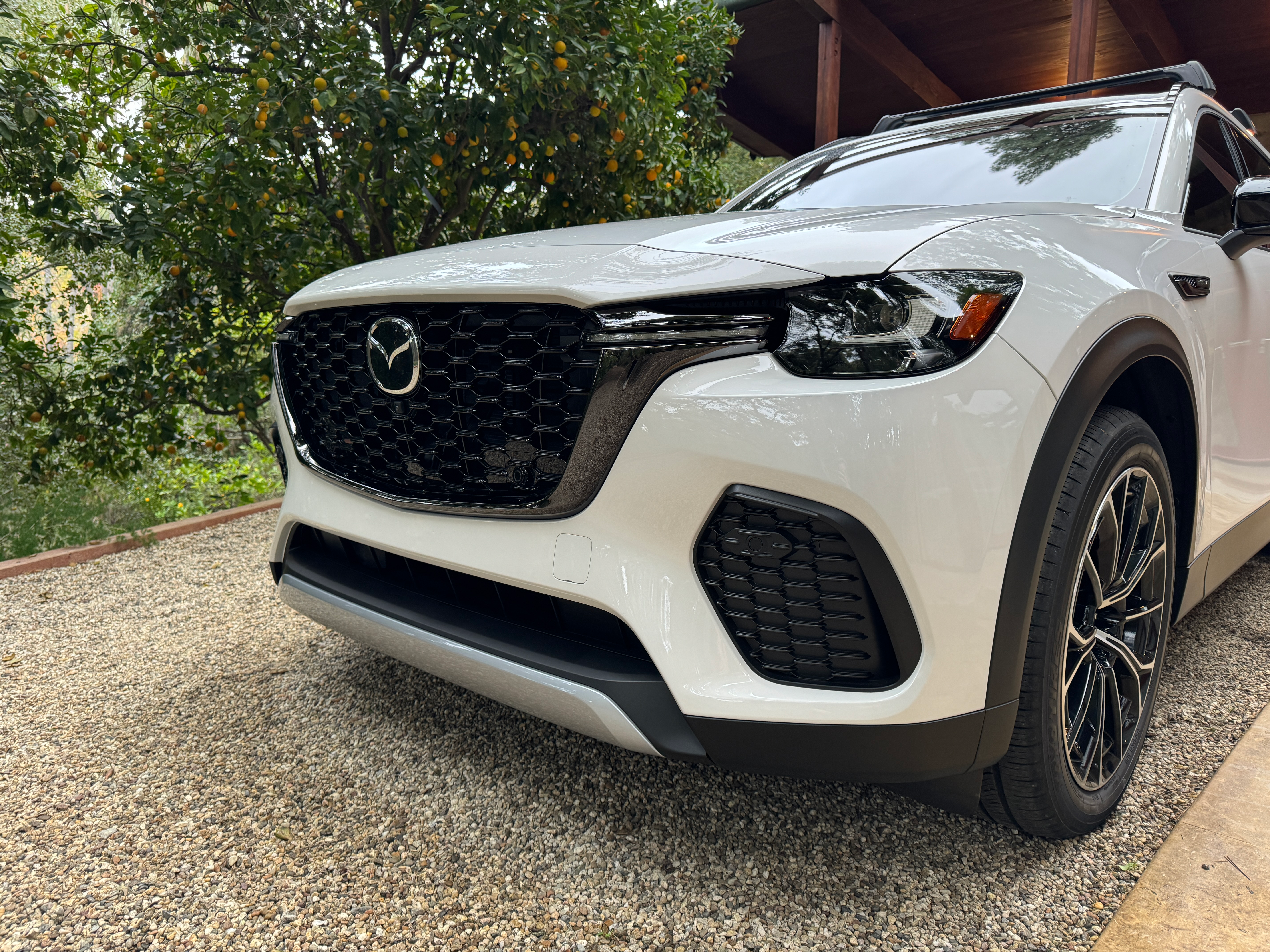 Detail view of the front bumper of a white 2025 Mazda CX-70