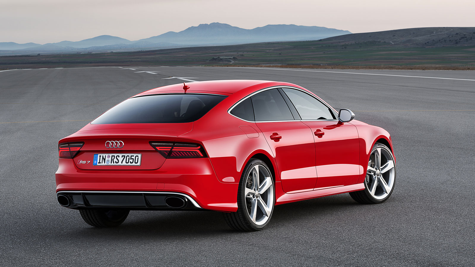 A red Audi RS7 parked on a runway. 