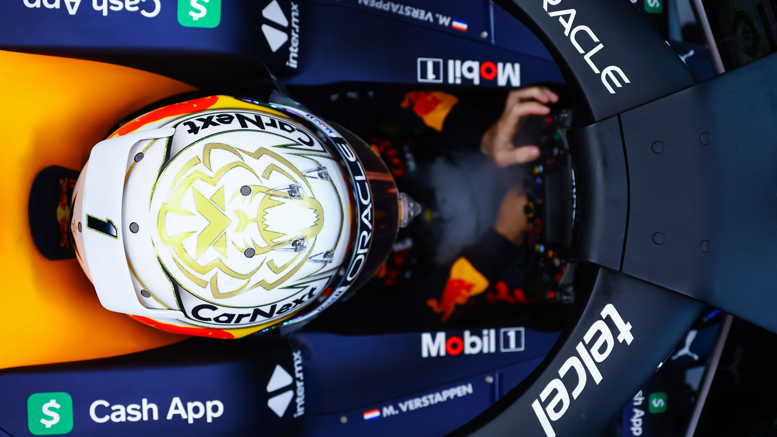 A photo looking down on Max Verstappen's helmet as he sits in his Red Bull car. 