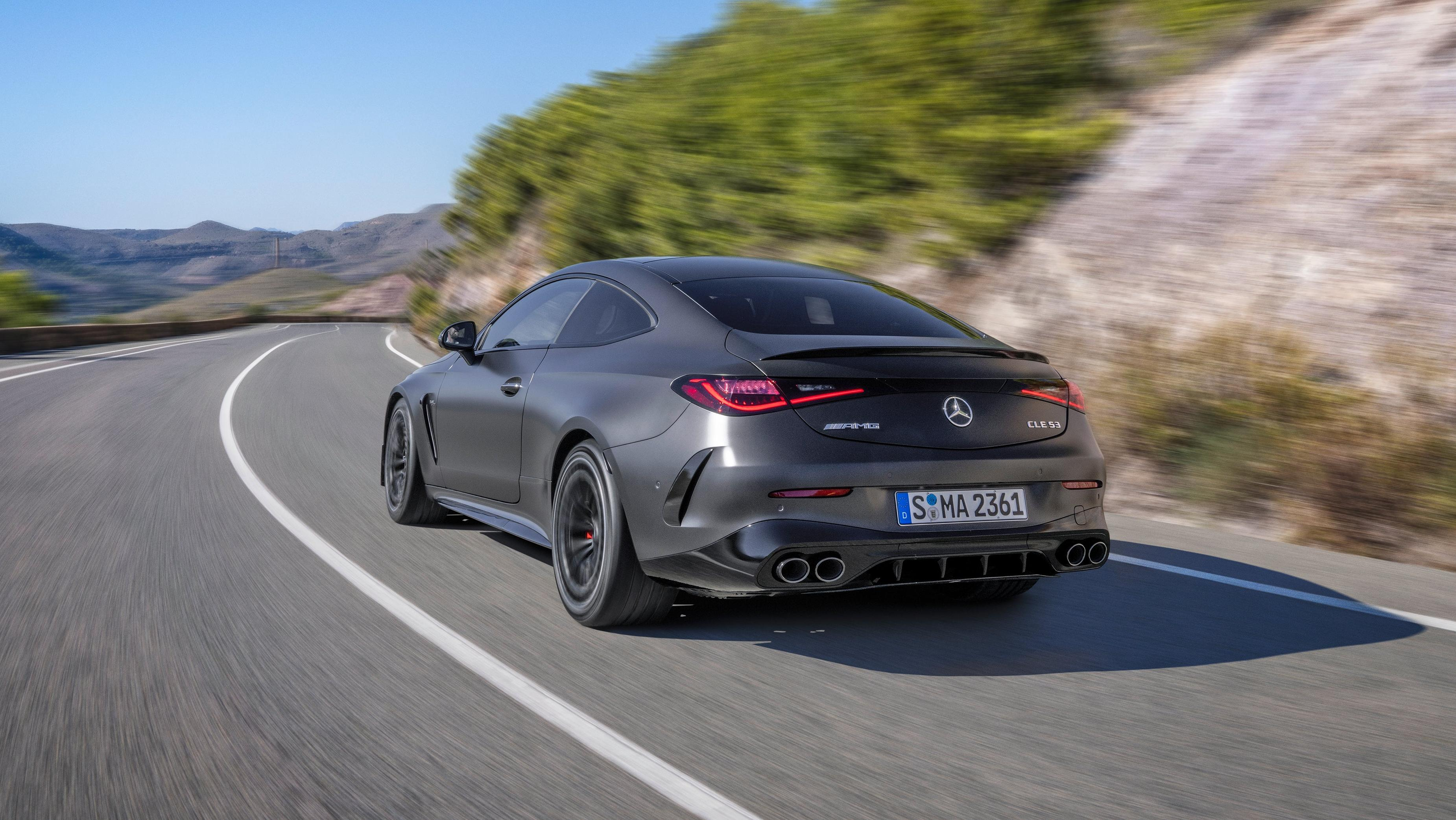 Rear 3/4 view of a matte black Mercedes-AMG CLE53 coupe driving on a road