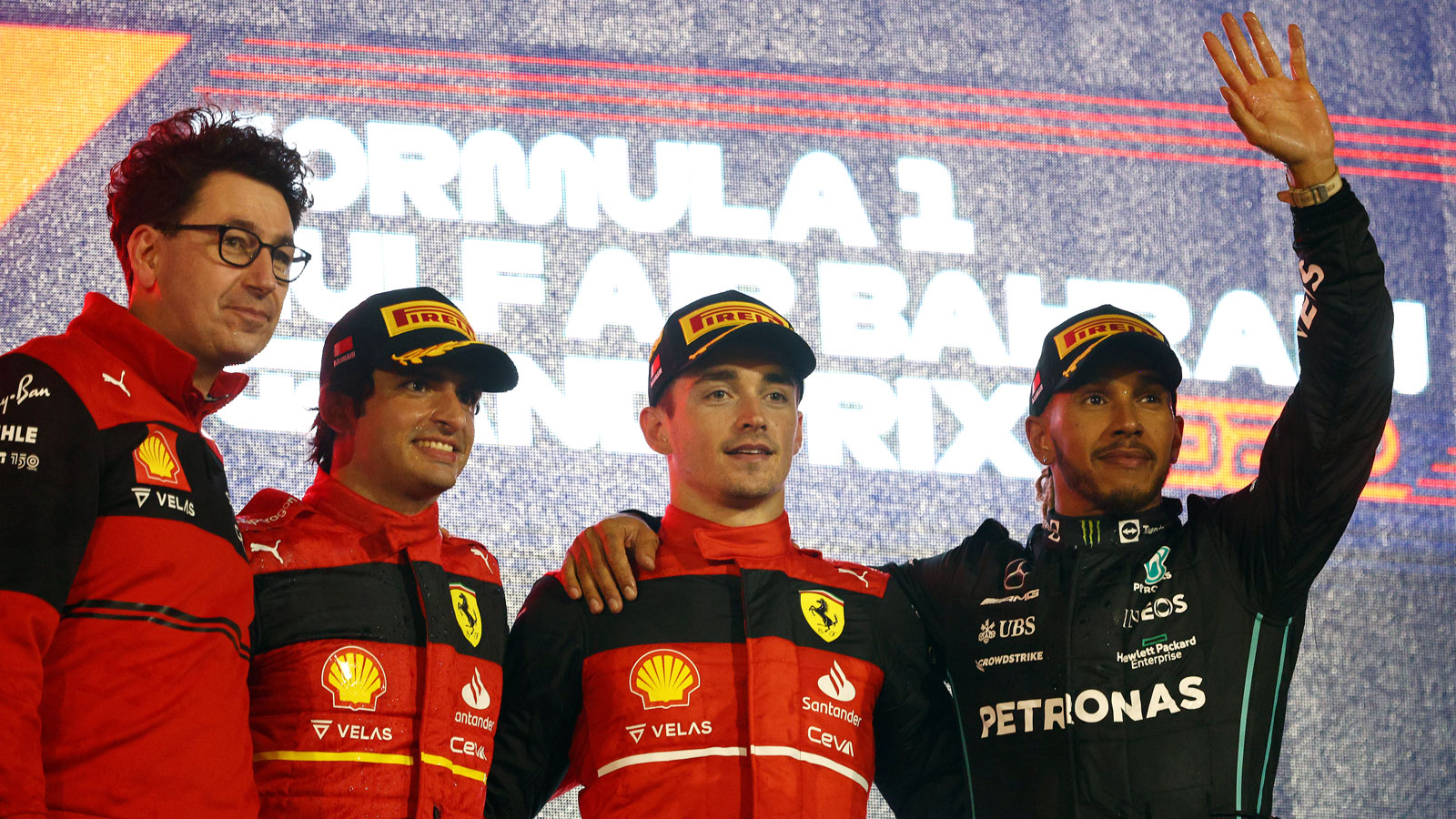 Mattia Binotto, Carlos Sainz, Charles LecLerc and Lewis Hamilton on the F1 podium. 