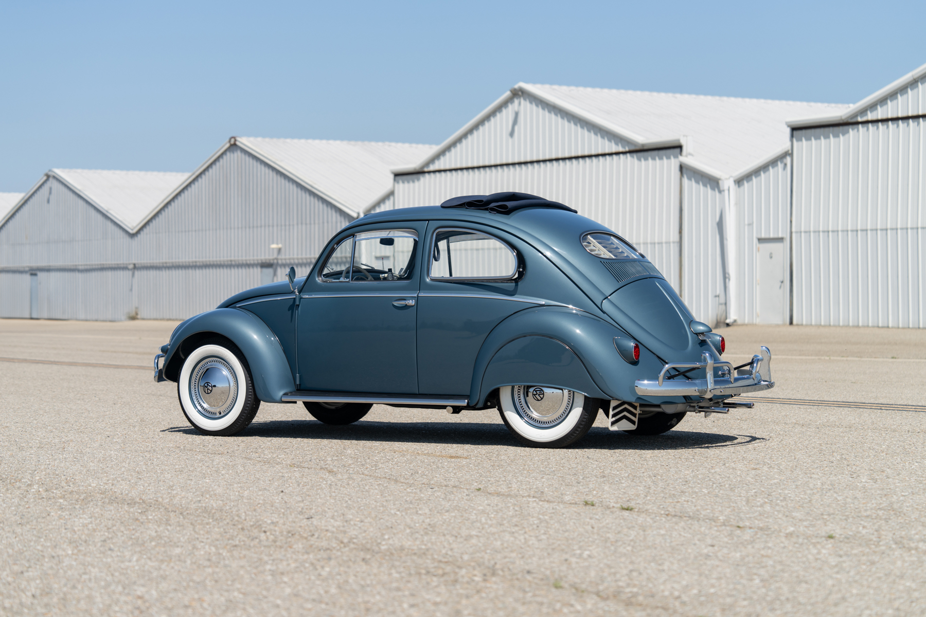 Rear 3/4 view of a blue vintage Volkswagen Beetle