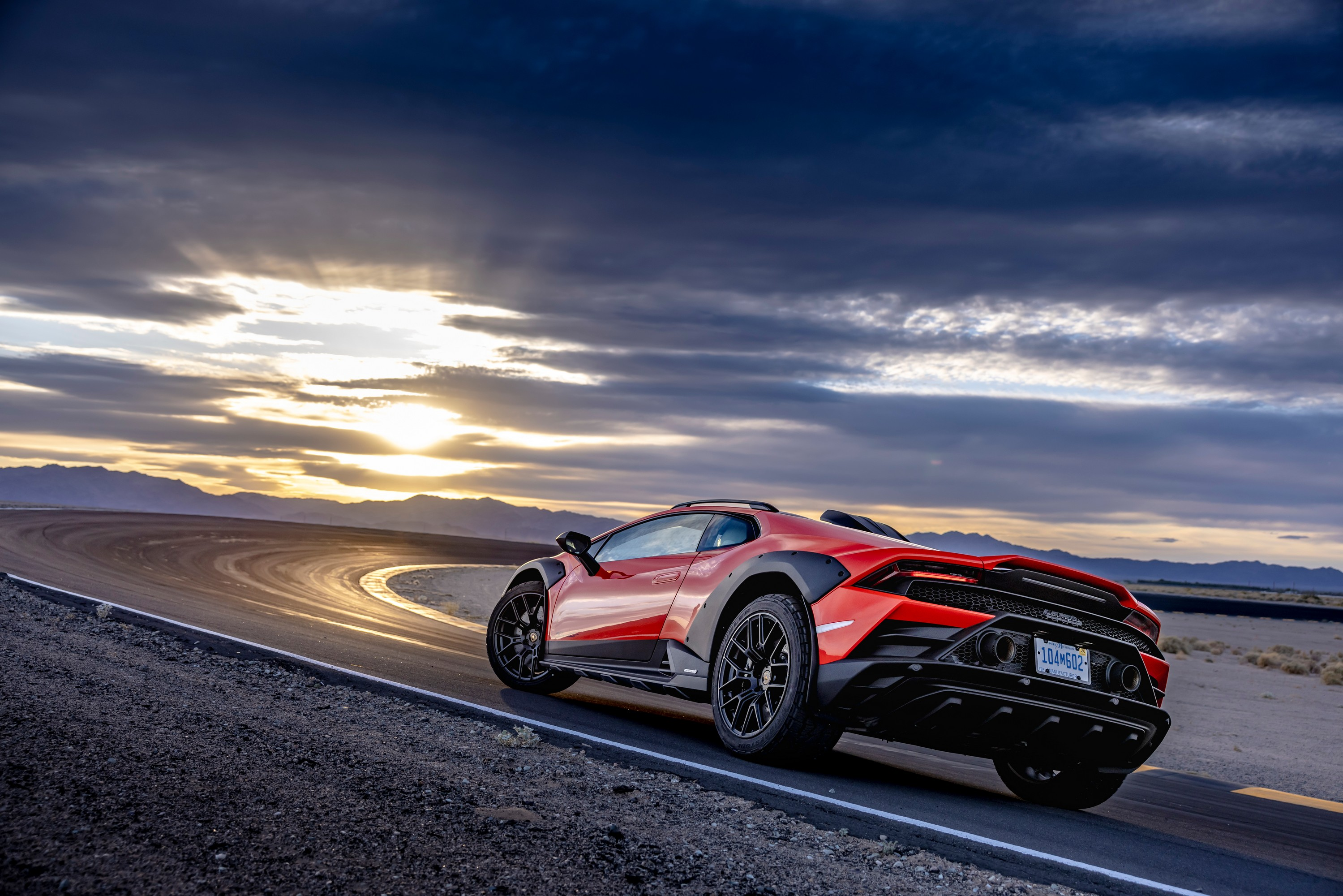 The rear three quarter view of the 2024 Lamborghini Huracan Sterrato on a track