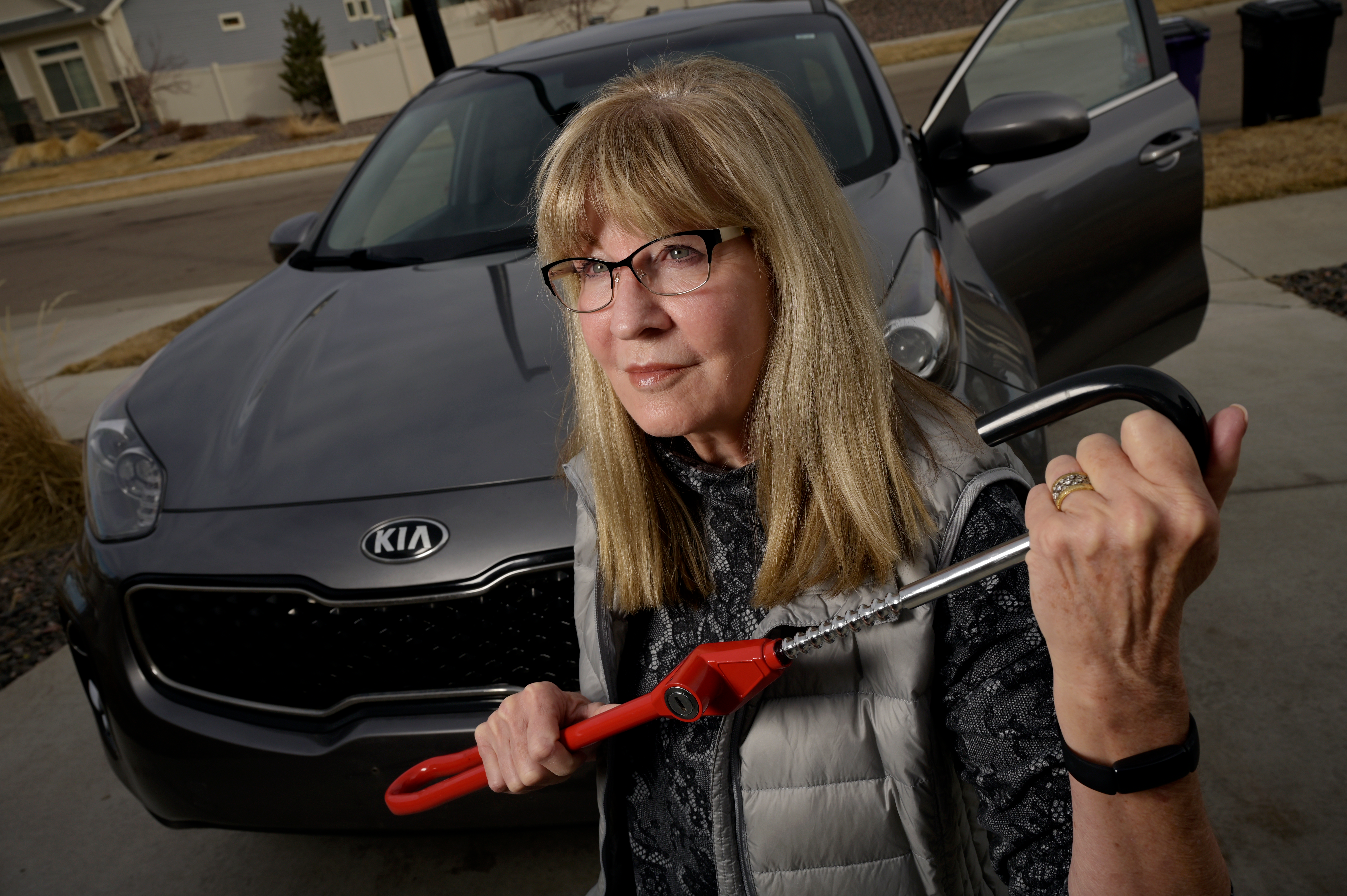 Debbie McClung holds the Club Steering Wheel Lock for her 2017 Kia Sportage at her home in Denver, Colorado on Tuesday, March 14, 2023. McClung said the car had been stolen twice.