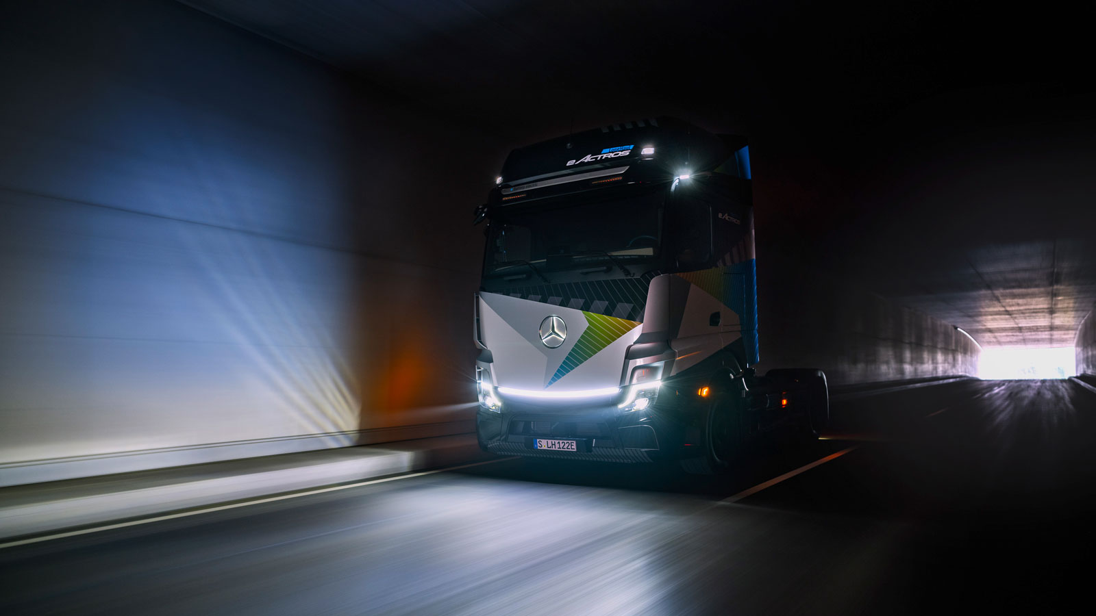 A photo of the front of the Mercedes-Benz eActros long haul electric truck as it drives through a tunnel. 