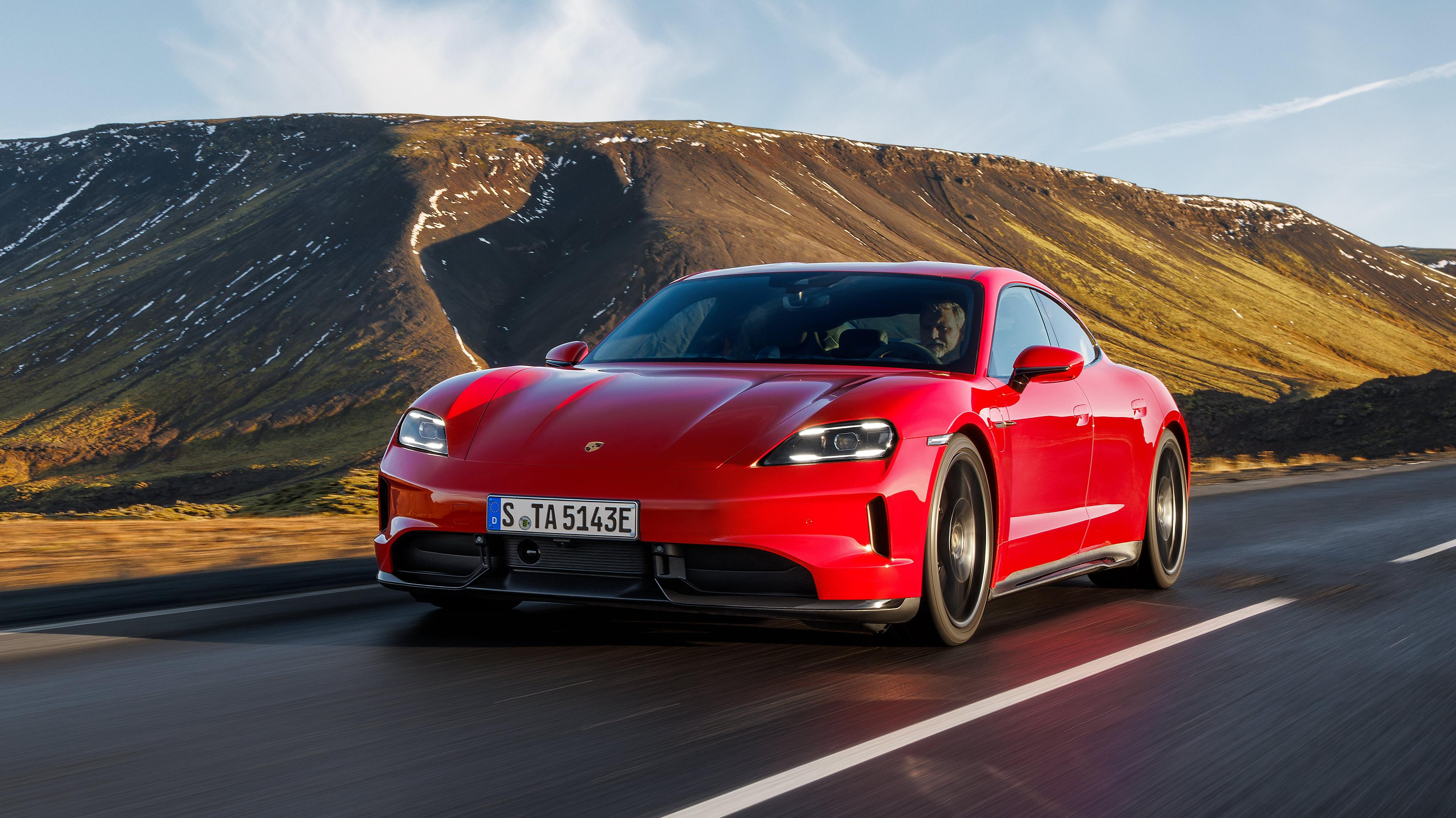 Front 3/4 view of a red 2025 Porsche Taycan GTS sedan