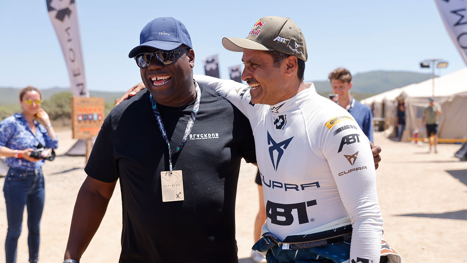 A photo of DJ Carl Cox with a racing driver in the Extreme E paddock. 