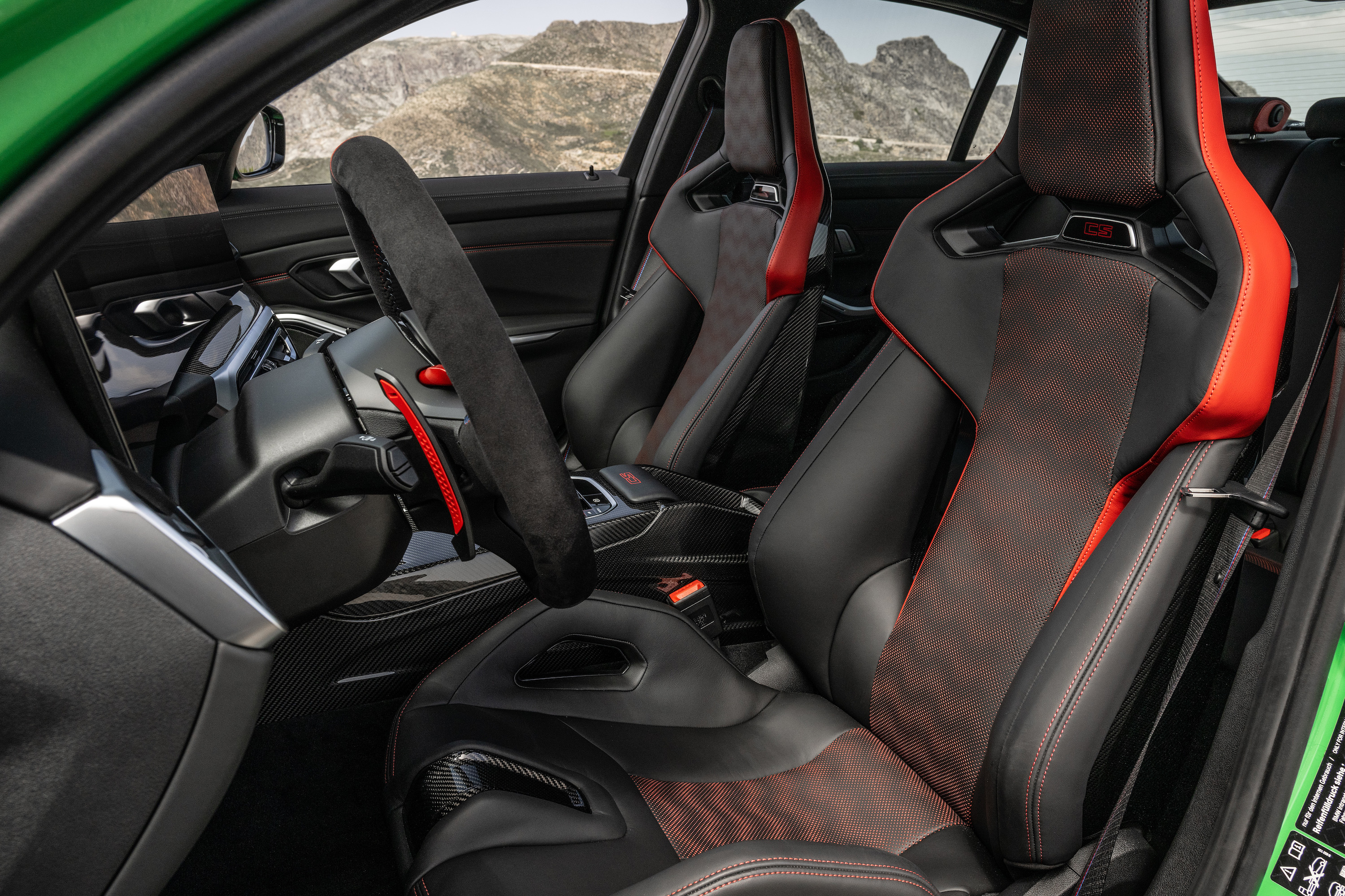 The interior of the 2024 BMW M3 CS with standard racing carbon bucket seats.