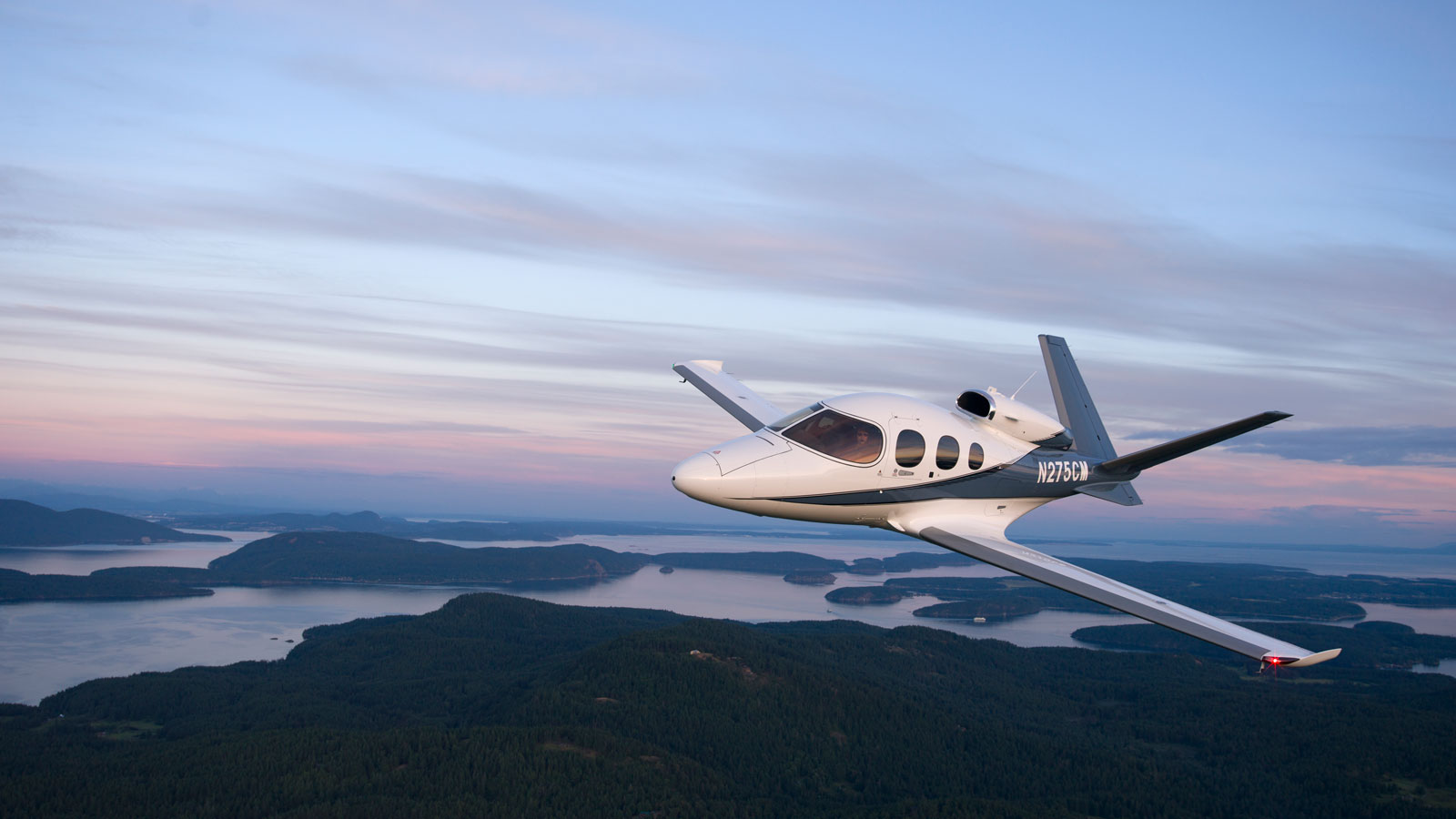 A photo of a Vision Jet flying in the air. 