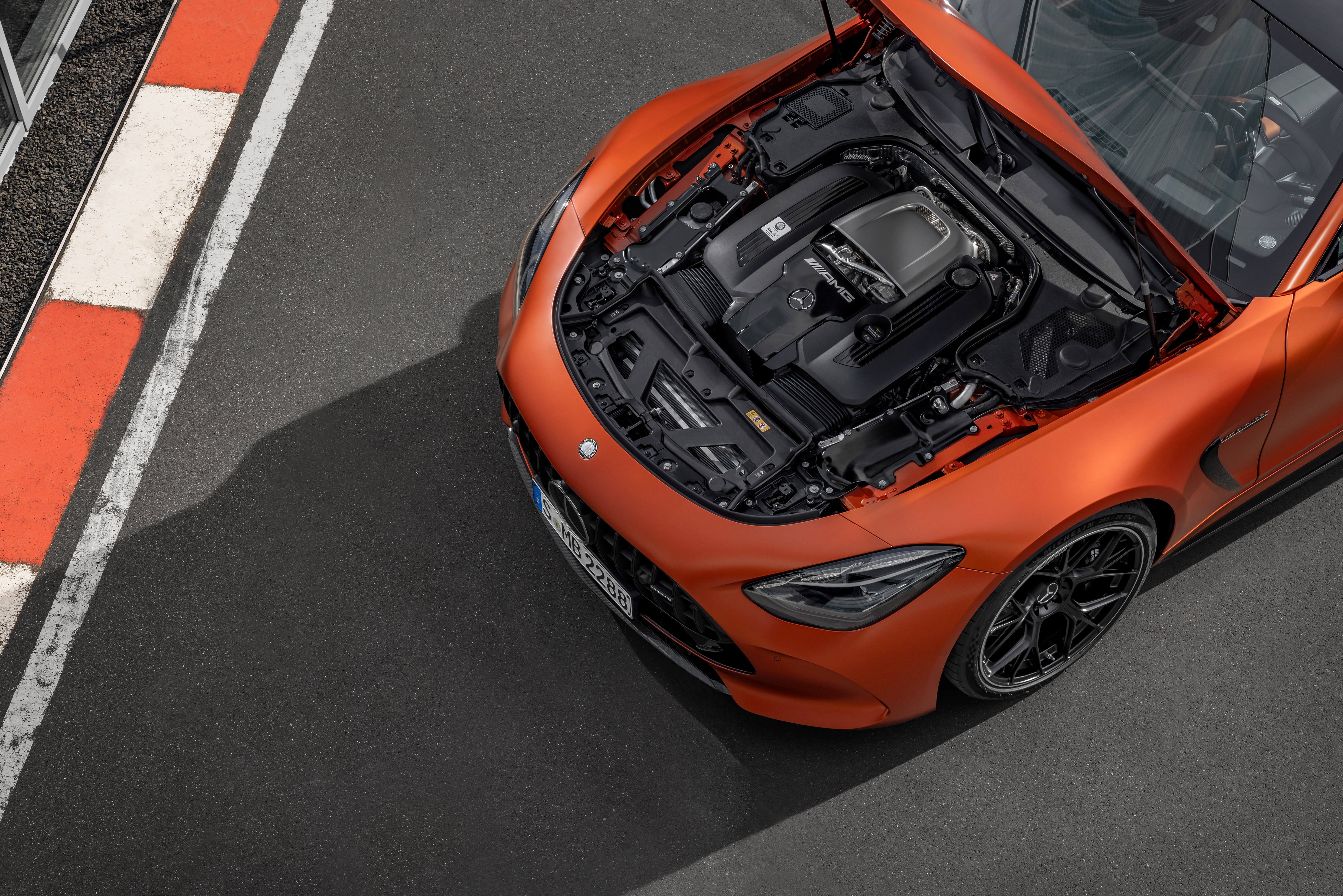 Engine bay of an orange Mercedes-AMG GT63 coupe