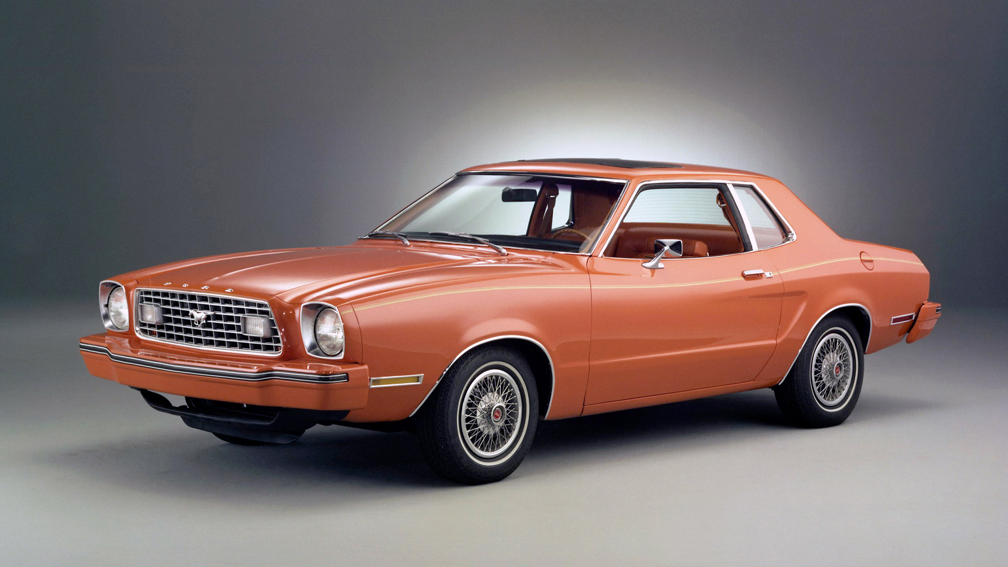 Red-orange Ford Mustang II front three-quarter angle view