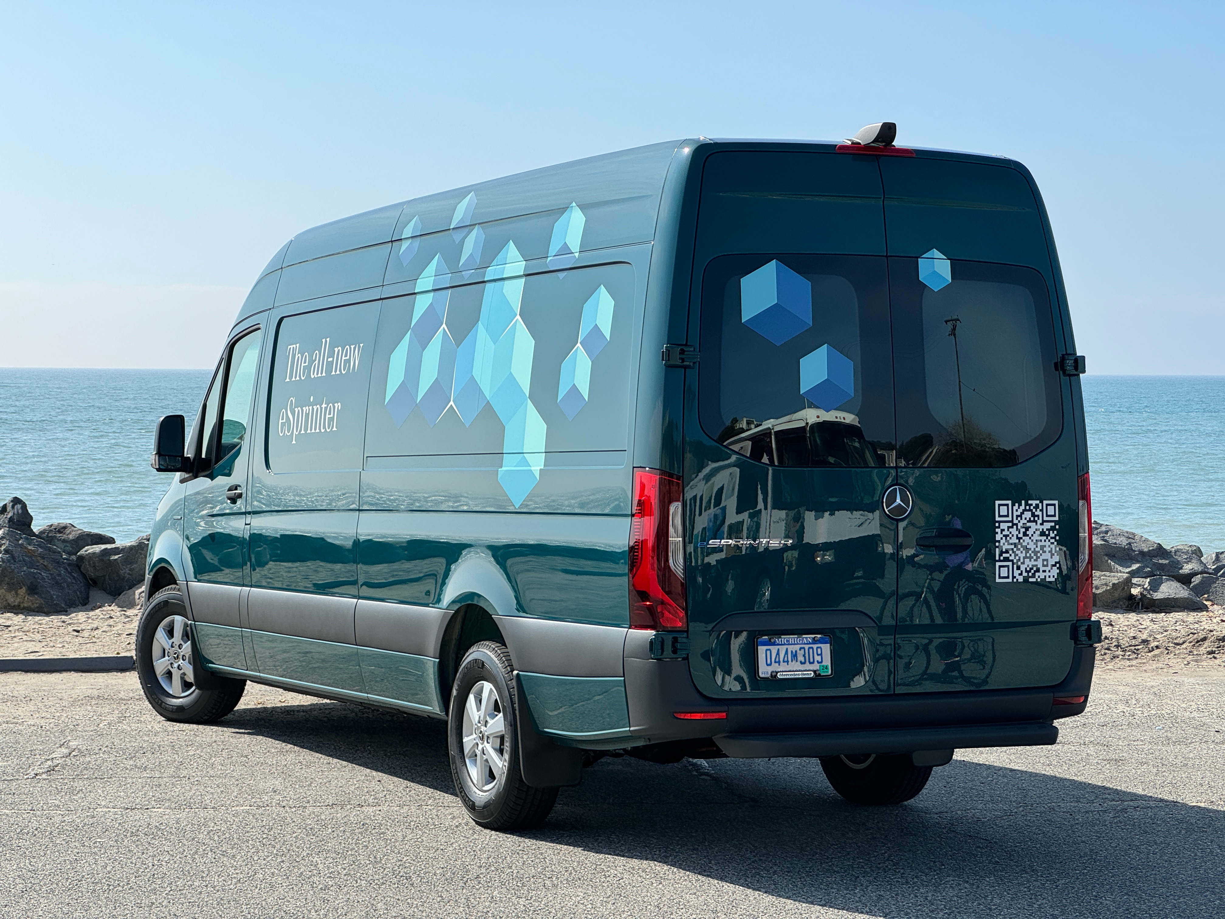 Rear 3/4 view of a green 2024 Mercedes-Benz eSprinter