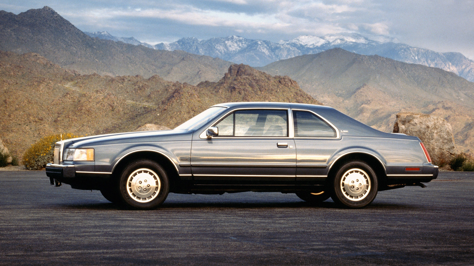 Silver-blue Lincoln Mark VII side profile view