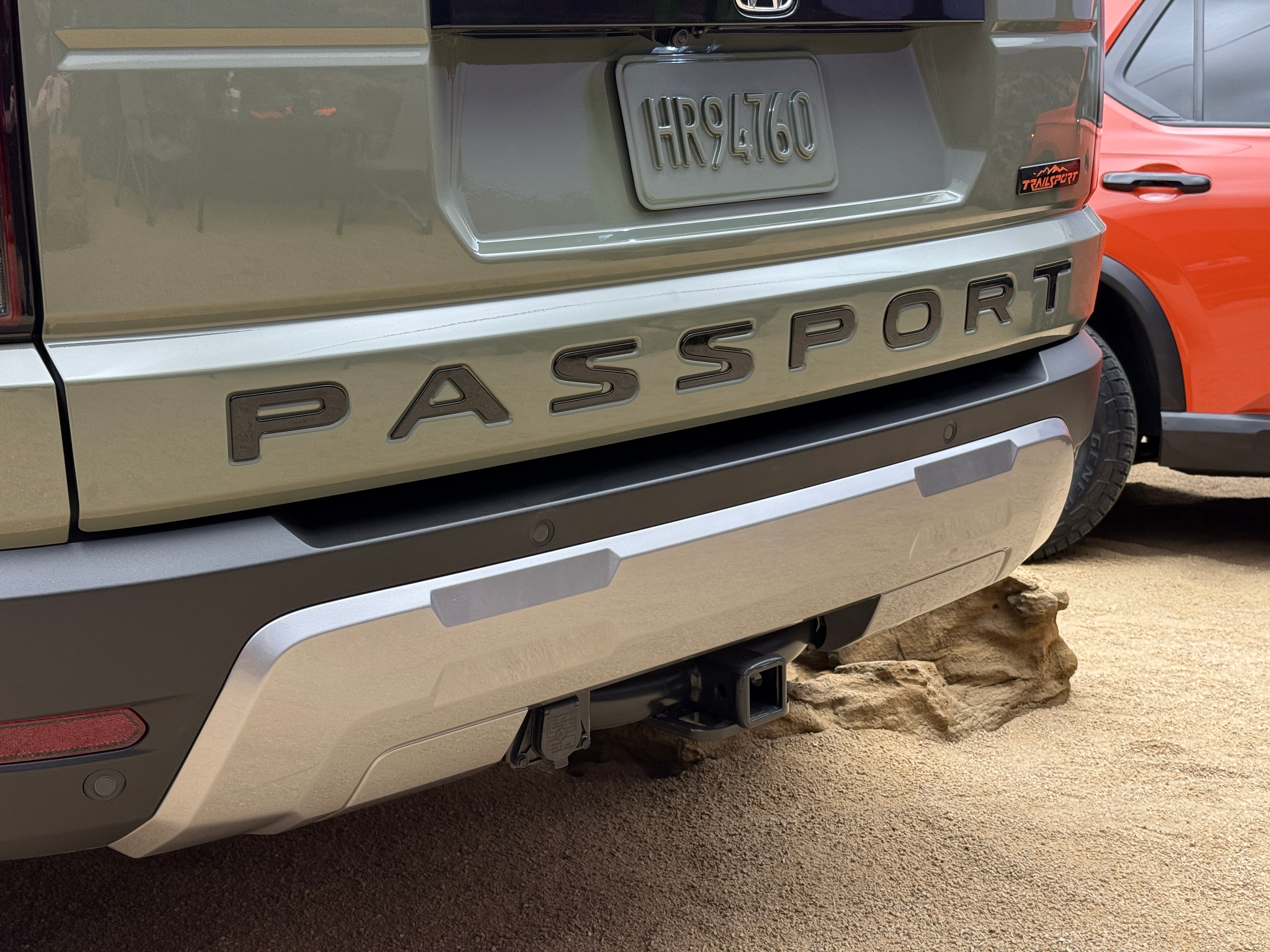 Rear badge of a green 2026 Honda Passport TrailSport