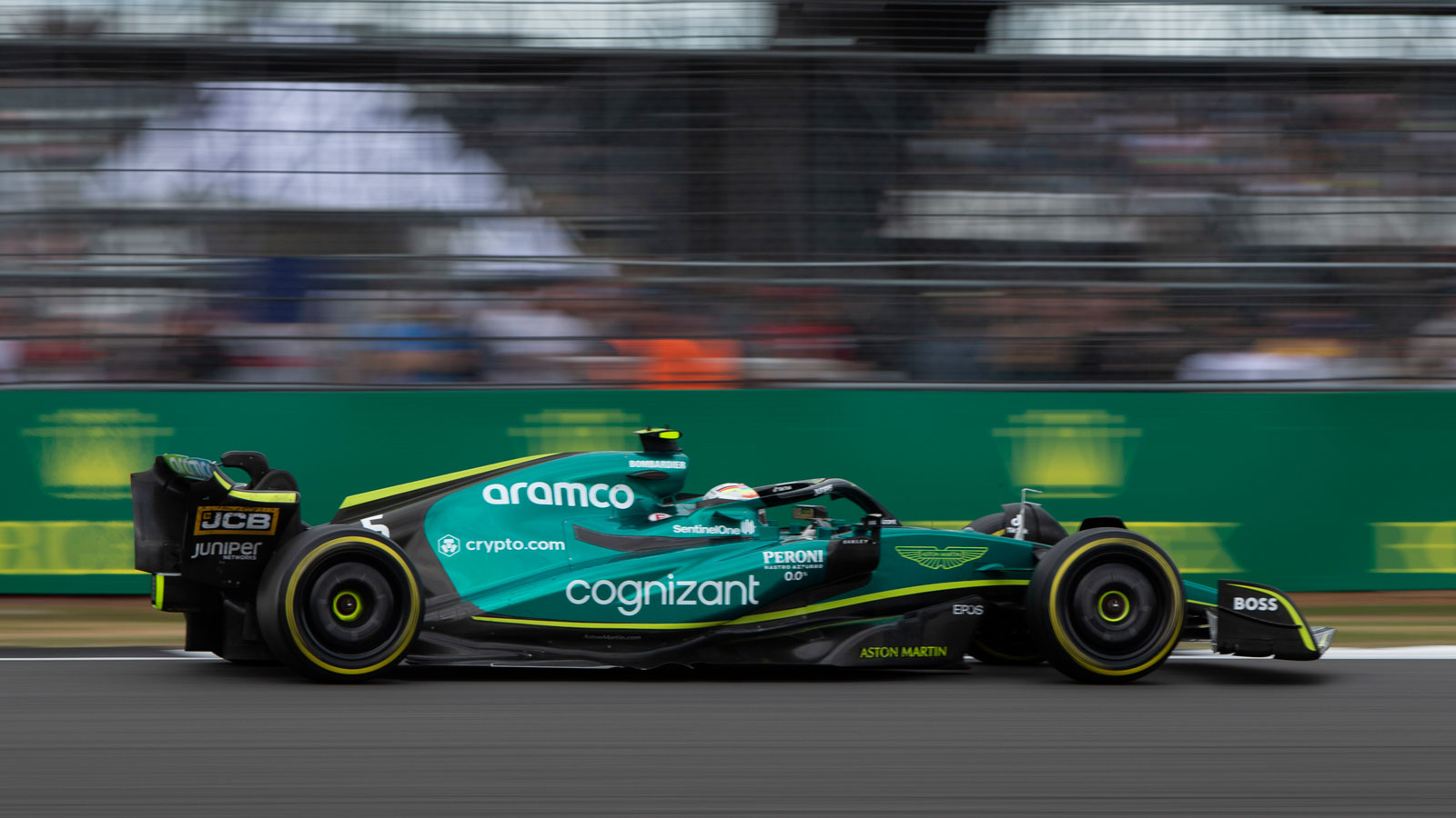 A photo of the green Aston Martin F1 car racing at Silverstone. 