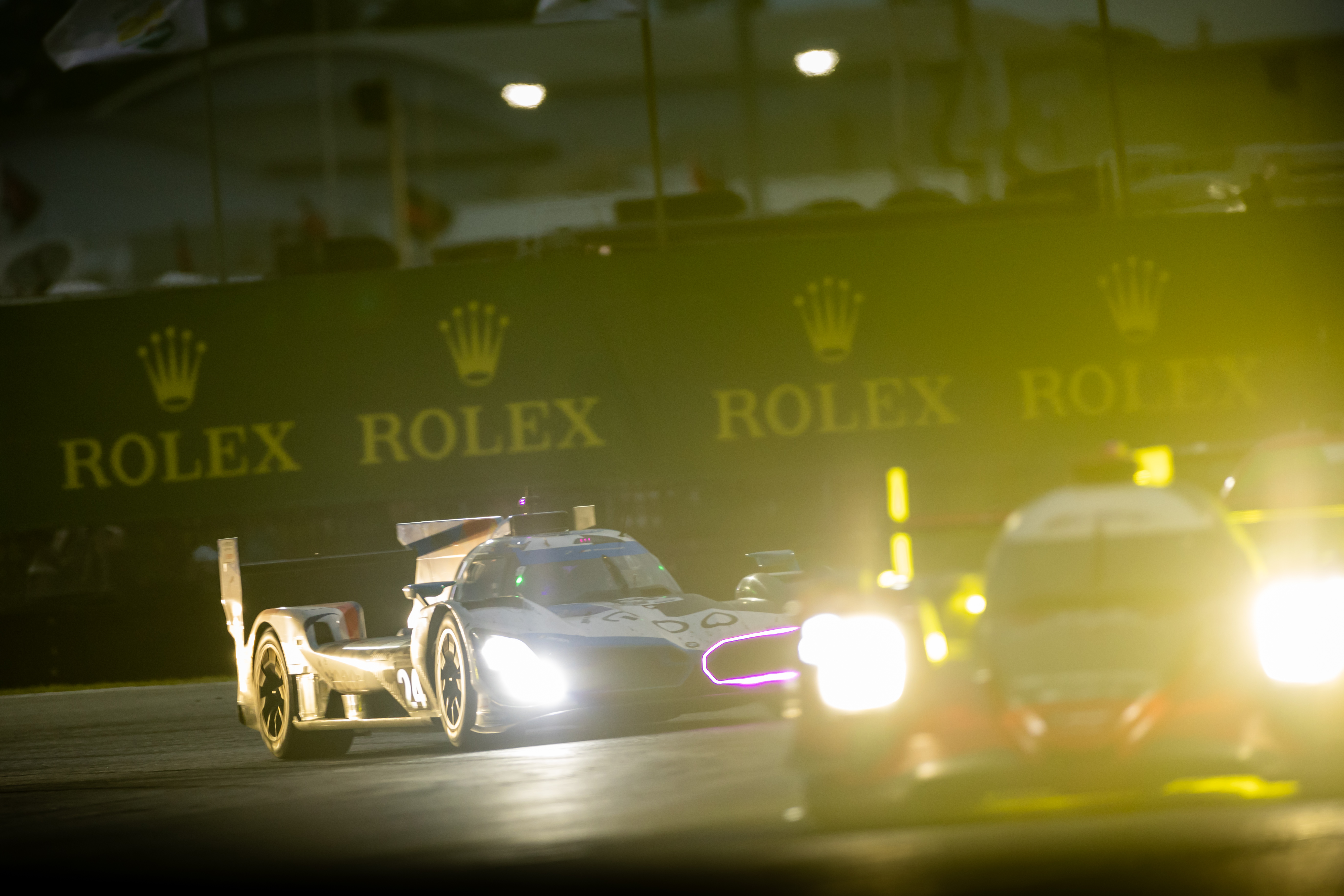 the BMW LMDh prototype following another prototype into one of the corners at the Rolex 24 at Daytona race. 