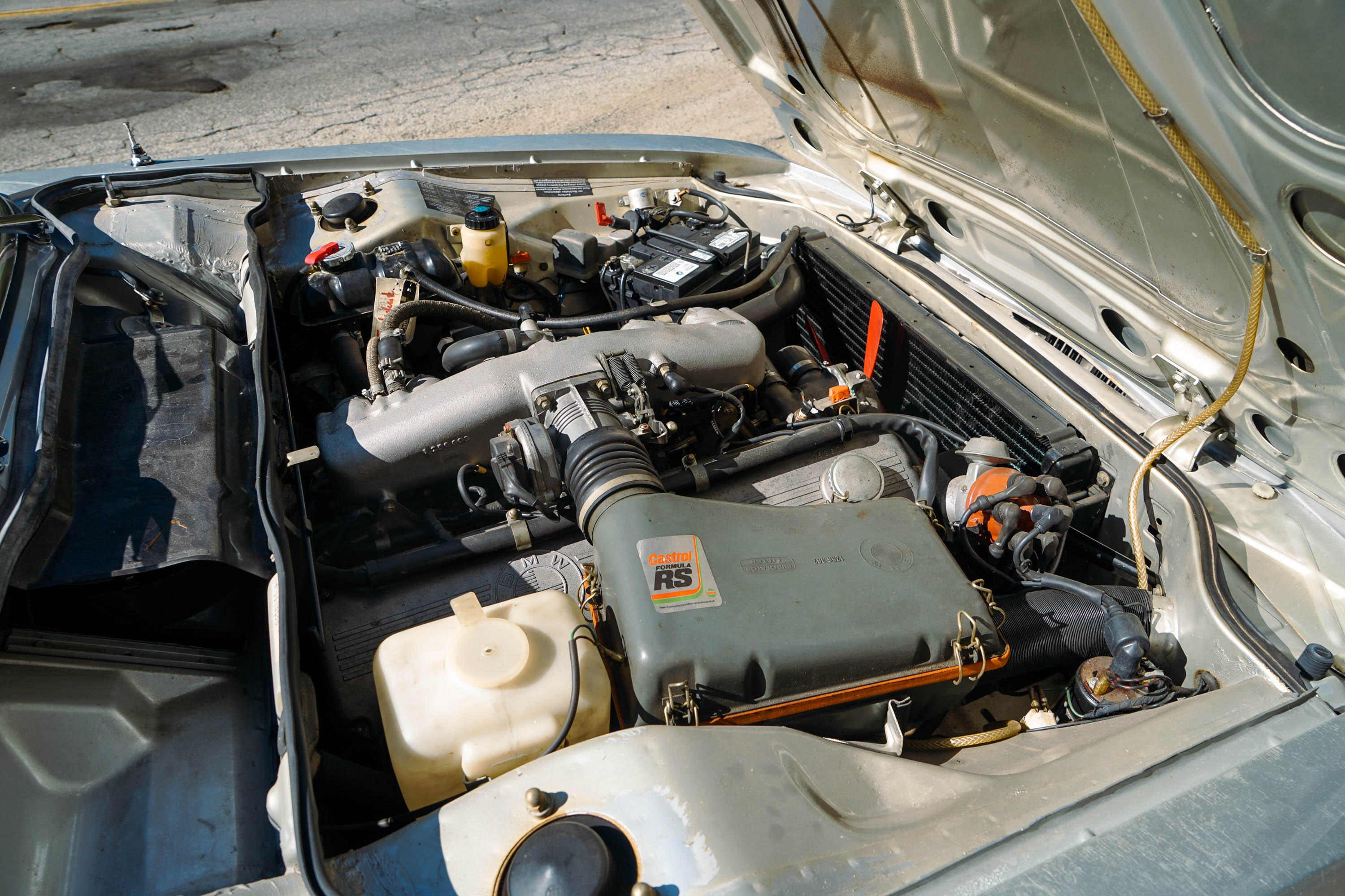 A large inline-six engine in a classic sports car.