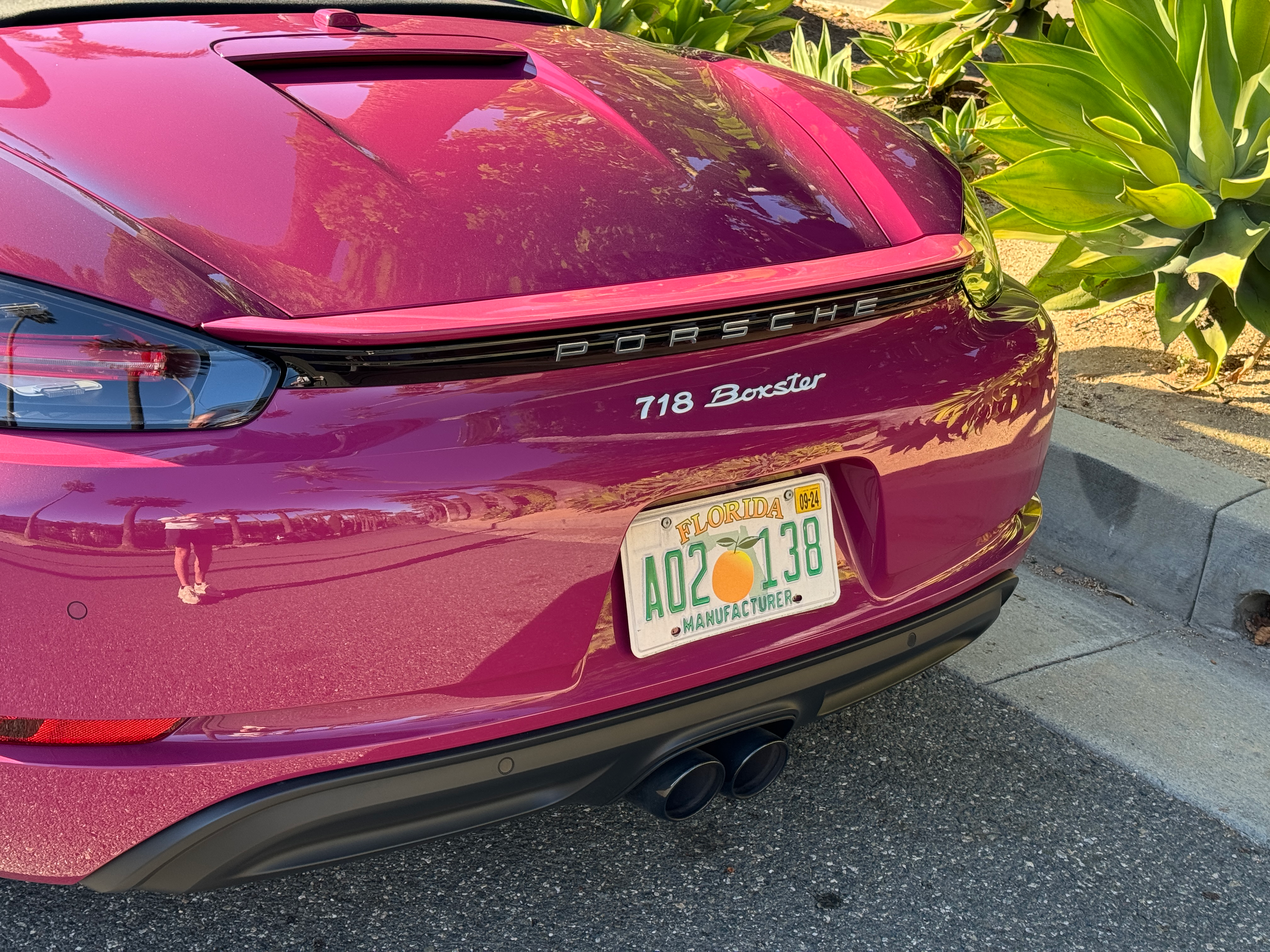 Rear end of a pink Porsche 718 Boxster Style Edition