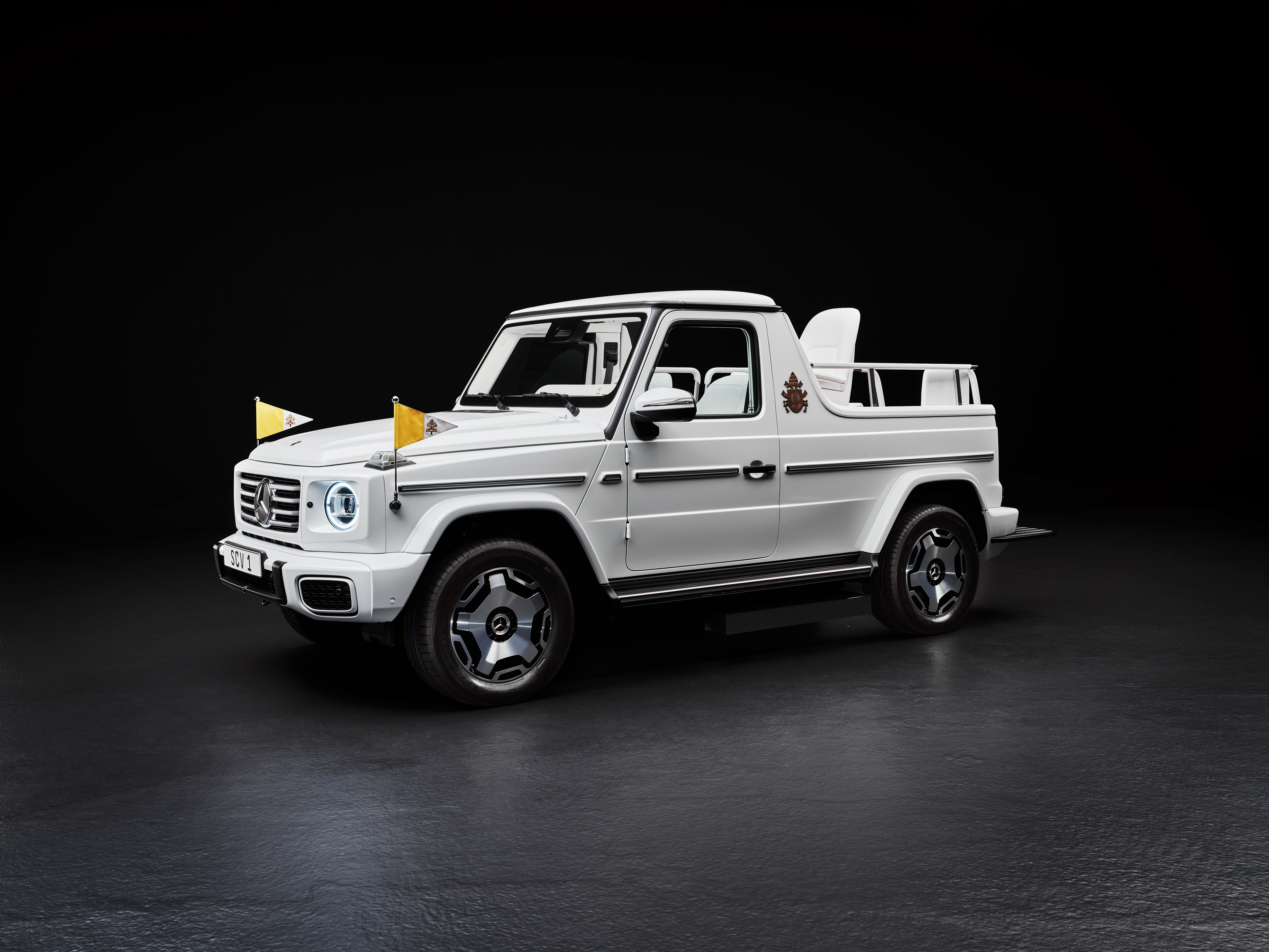 Front 3/4 view of the white Mercedes-Benz G580 Popemobile