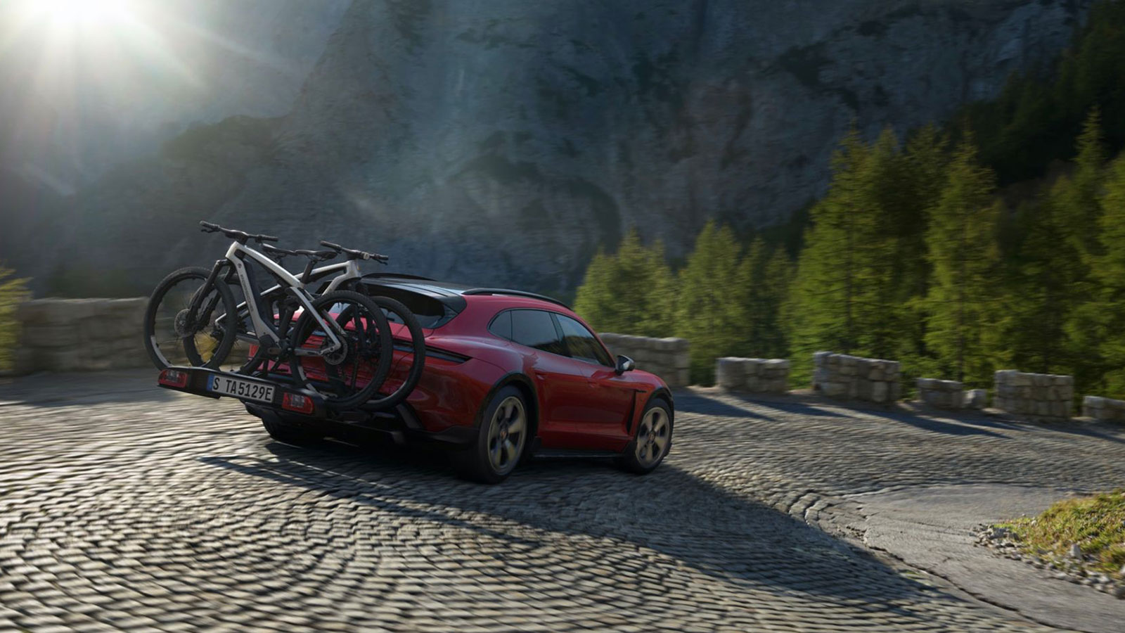 A render of a Porsche Taycan carrying two electric bikes. 