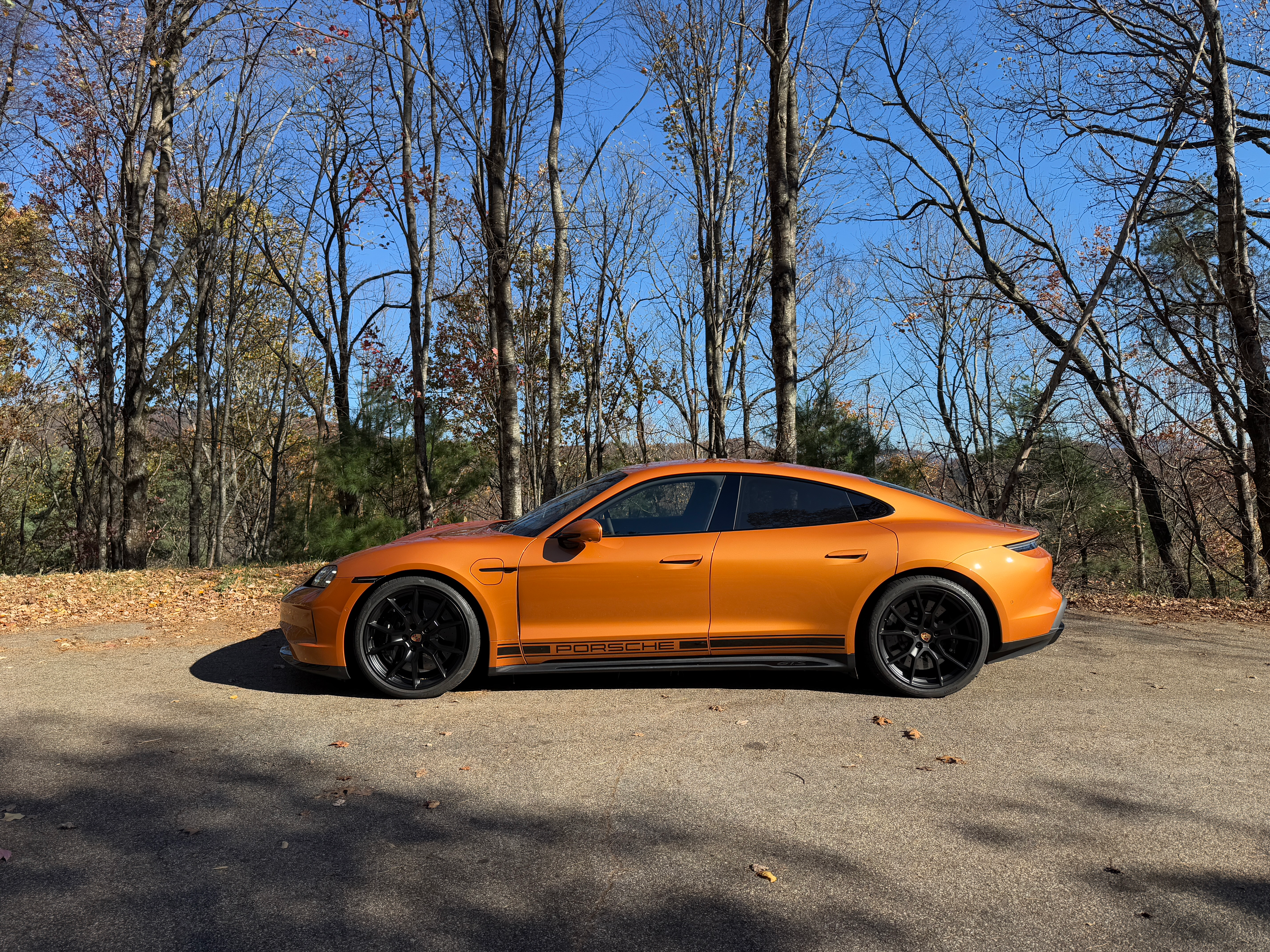 Side view of a Nordic Gold 2025 Porsche Taycan GTS sedan