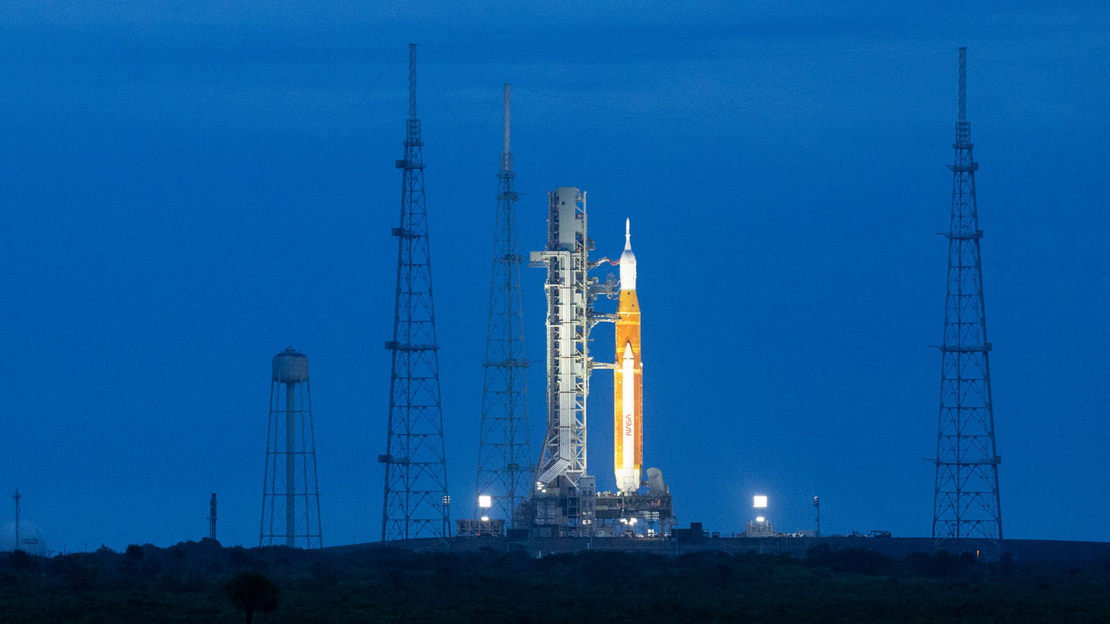 A photo of the NASA Artemis 1 rocket at night. 