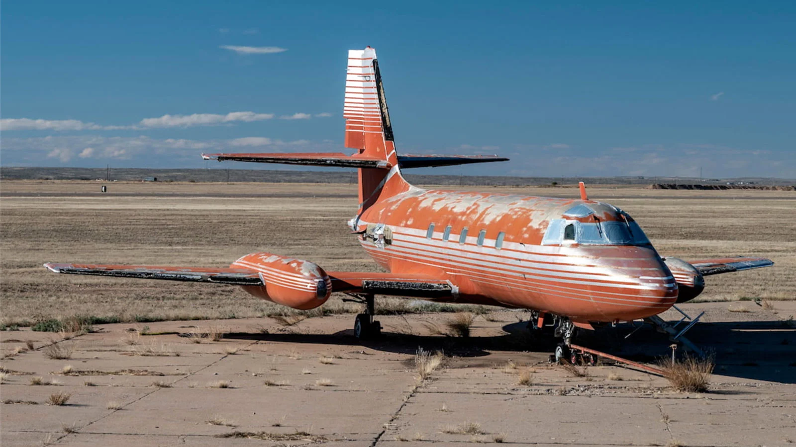 A photo of a red and silver plane. 