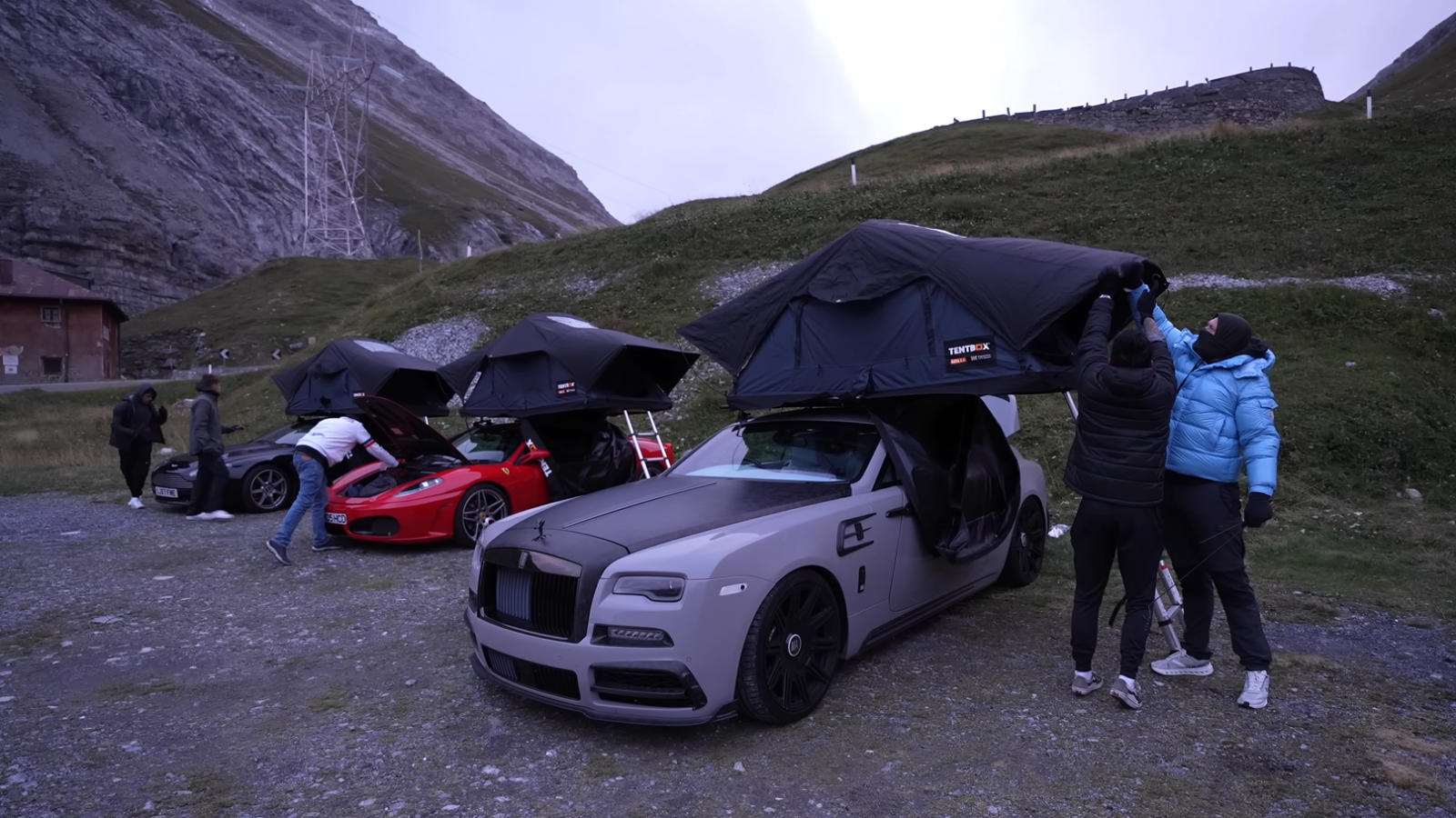 A photo of three supercars with rooftop tents installed. 