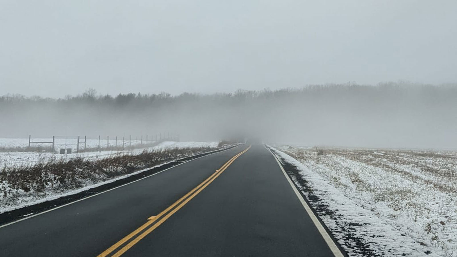 A photo of a road in the mist. 