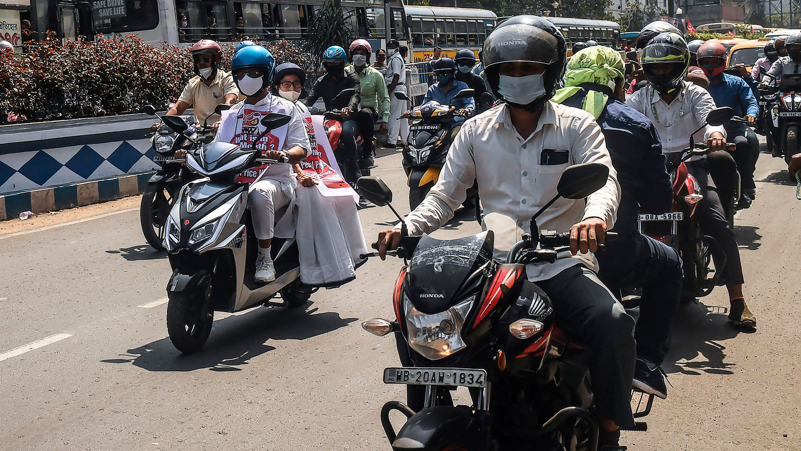 Commuters riding scooters in an Indian city. 